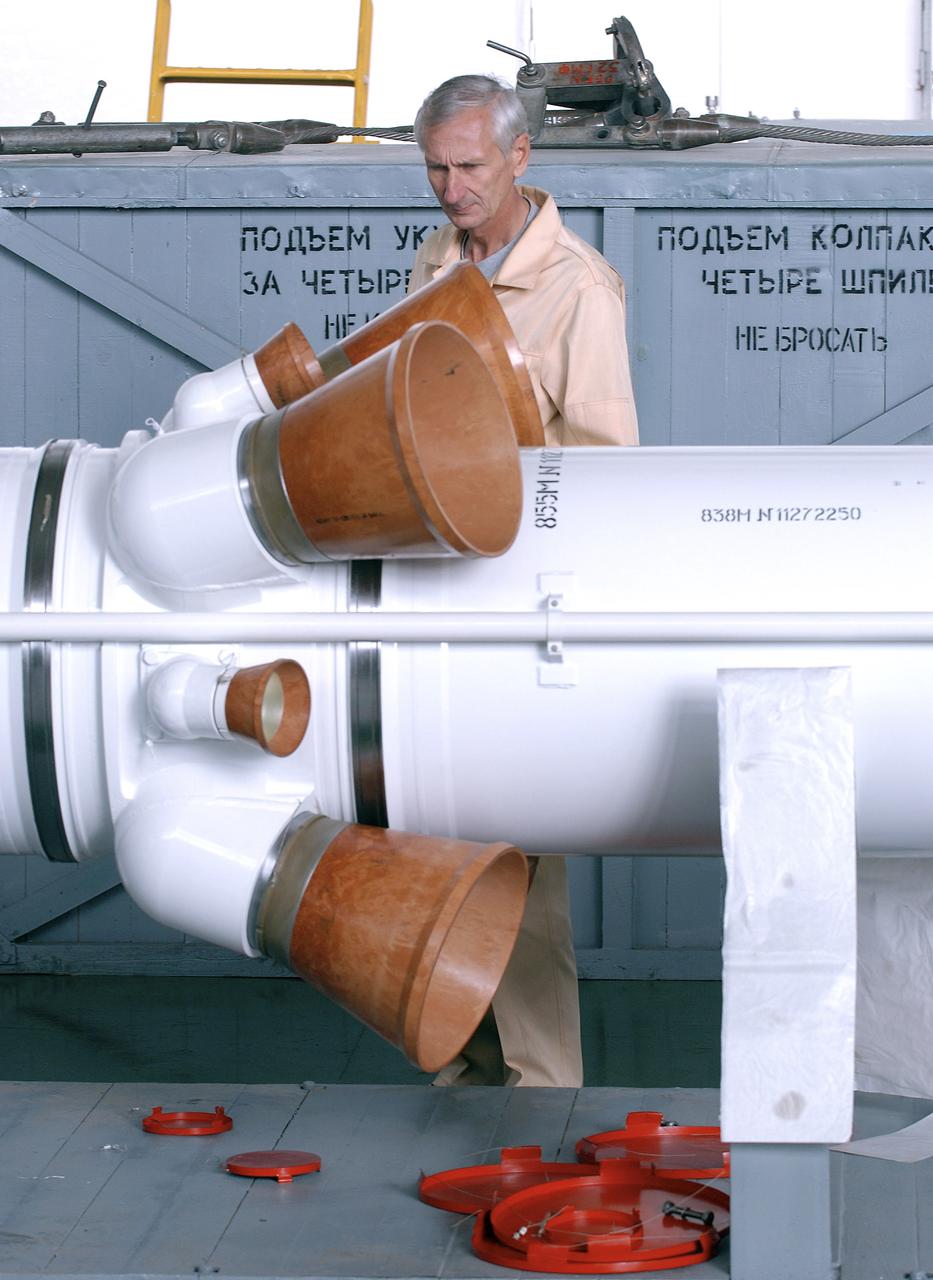 The Soyuz TMA-5 spacecraft is mated to its booster rocket in a processing hangar at the Baikonur Cosmodrome in Kazakhstan Monday, October 11, 2004, in preparation for its rollout to the launch pad October 12 and its liftoff October 14 to carry Expedition 10 Commander and NASA Science Officer Leroy Chiao, Flight Engineer and Soyuz Commander Salizhan Sharipov and Russian Space Forces cosmonaut Yuri Shargin to the International Space Station.  Photo Credit: (NASA/Bill Ingalls)