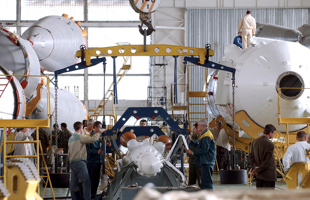 The Soyuz TMA-5 spacecraft is mated to its booster rocket in a processing hangar at the Baikonur Cosmodrome in Kazakhstan Monday, October 11, 2004, in preparation for its rollout to the launch pad October 12 and its liftoff October 14 to carry Expedition 10 Commander and NASA Science Officer Leroy Chiao, Flight Engineer and Soyuz Commander Salizhan Sharipov and Russian Space Forces cosmonaut Yuri Shargin to the International Space Station.  Photo Credit: (NASA/Bill Ingalls)