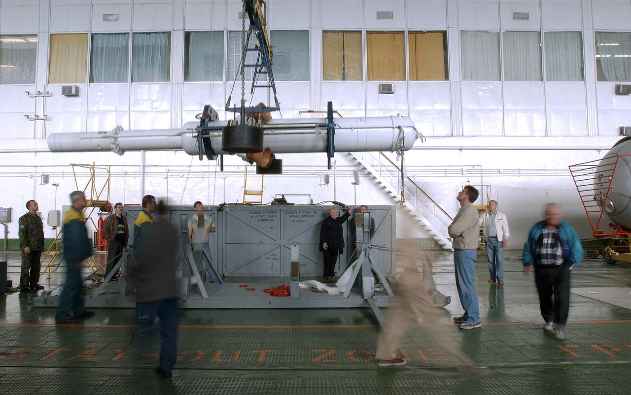 The Soyuz TMA-5 spacecraft is mated to its booster rocket in a processing hangar at the Baikonur Cosmodrome in Kazakhstan Monday, October 11, 2004, in preparation for its rollout to the launch pad October 12 and its liftoff October 14 to carry Expedition 10 Commander and NASA Science Officer Leroy Chiao, Flight Engineer and Soyuz Commander Salizhan Sharipov and Russian Space Forces cosmonaut Yuri Shargin to the International Space Station.  Photo Credit: (NASA/Bill Ingalls)