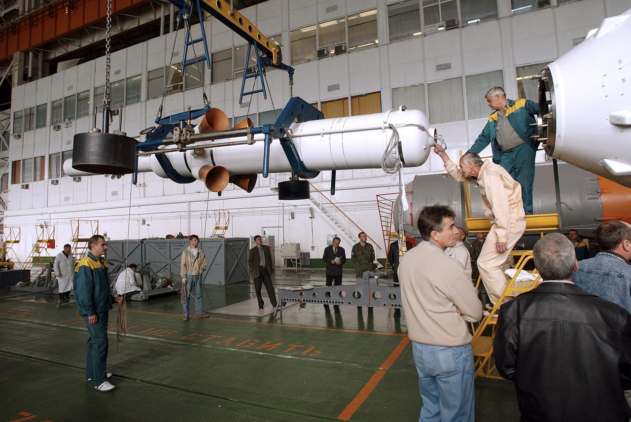 The Soyuz TMA-5 spacecraft is mated to its booster rocket in a processing hangar at the Baikonur Cosmodrome in Kazakhstan Monday, October 11, 2004, in preparation for its rollout to the launch pad October 12 and its liftoff October 14 to carry Expedition 10 Commander and NASA Science Officer Leroy Chiao, Flight Engineer and Soyuz Commander Salizhan Sharipov and Russian Space Forces cosmonaut Yuri Shargin to the International Space Station.  Photo Credit: (NASA/Bill Ingalls)