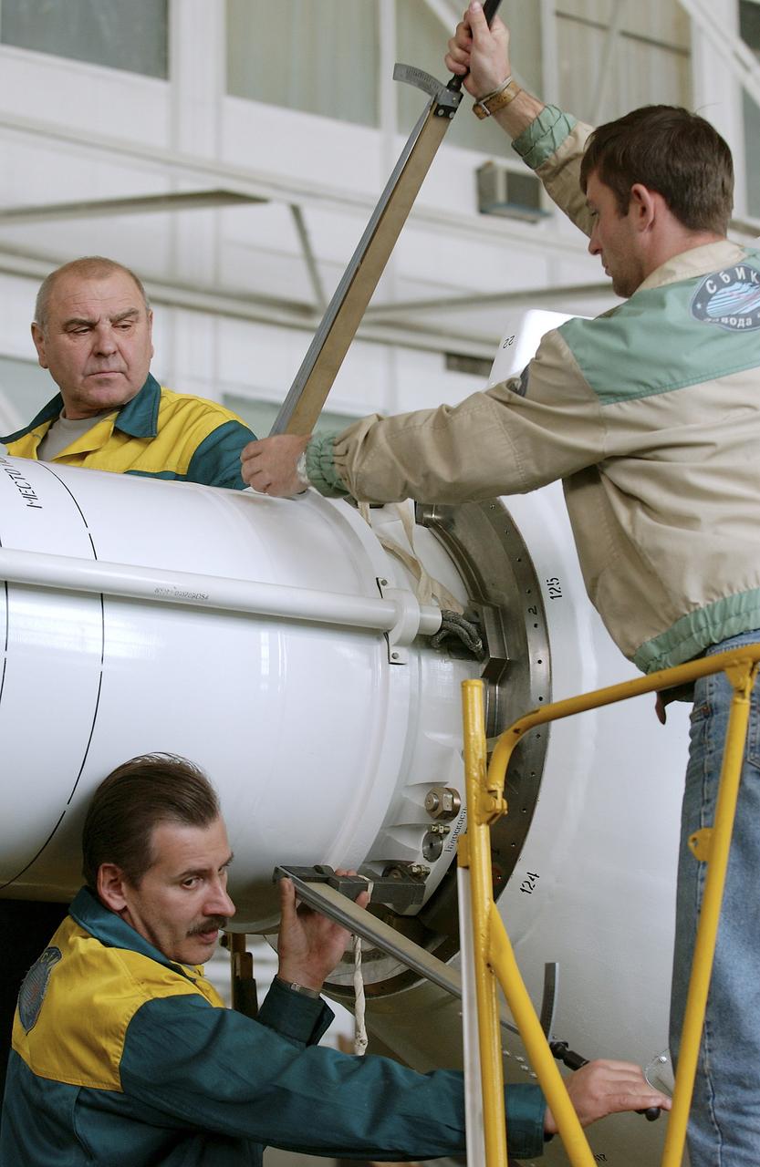 The Soyuz TMA-5 spacecraft is mated to its booster rocket in a processing hangar at the Baikonur Cosmodrome in Kazakhstan Monday, October 11, 2004, in preparation for its rollout to the launch pad October 12 and its liftoff October 14 to carry Expedition 10 Commander and NASA Science Officer Leroy Chiao, Flight Engineer and Soyuz Commander Salizhan Sharipov and Russian Space Forces cosmonaut Yuri Shargin to the International Space Station.  Photo Credit: (NASA/Bill Ingalls)