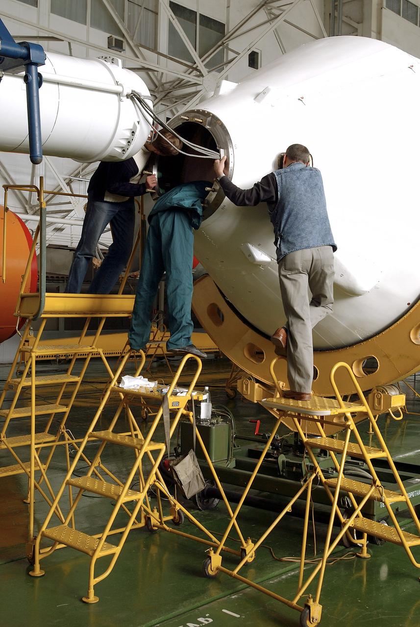 The Soyuz TMA-5 spacecraft is mated to its booster rocket in a processing hangar at the Baikonur Cosmodrome in Kazakhstan Monday, October 11, 2004, in preparation for its rollout to the launch pad October 12 and its liftoff October 14 to carry Expedition 10 Commander and NASA Science Officer Leroy Chiao, Flight Engineer and Soyuz Commander Salizhan Sharipov and Russian Space Forces cosmonaut Yuri Shargin to the International Space Station.  Photo Credit: (NASA/Bill Ingalls)