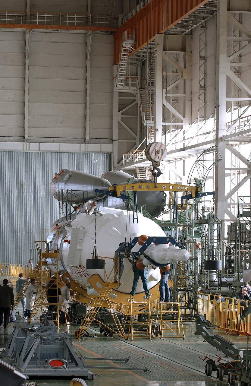 The Soyuz TMA-5 spacecraft is mated to its booster rocket in a processing hangar at the Baikonur Cosmodrome in Kazakhstan Monday, October 11, 2004, in preparation for its rollout to the launch pad October 12 and its liftoff October 14 to carry Expedition 10 Commander and NASA Science Officer Leroy Chiao, Flight Engineer and Soyuz Commander Salizhan Sharipov and Russian Space Forces cosmonaut Yuri Shargin to the International Space Station.  Photo Credit: (NASA/Bill Ingalls)