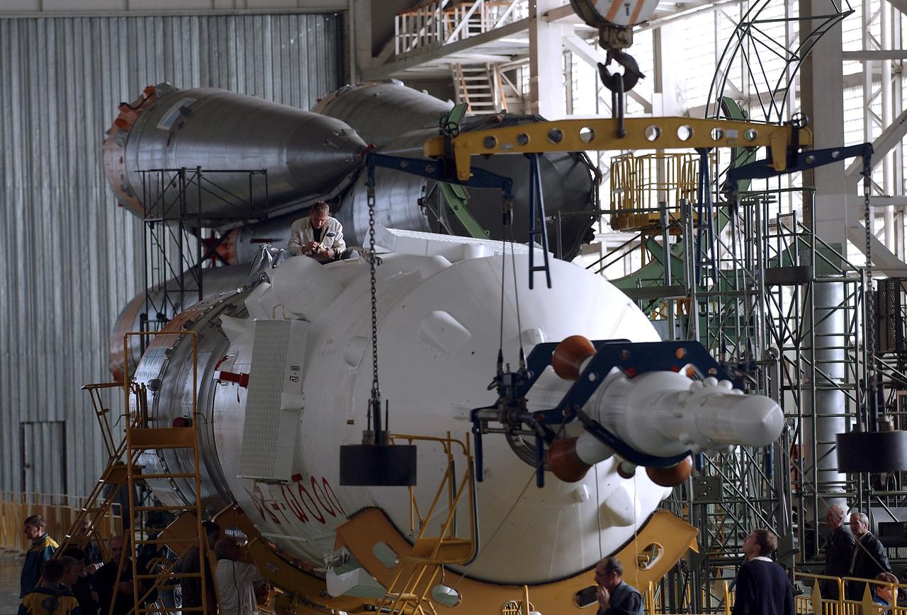 The Soyuz TMA-5 spacecraft is mated to its booster rocket in a processing hangar at the Baikonur Cosmodrome in Kazakhstan Monday, October 11, 2004, in preparation for its rollout to the launch pad October 12 and its liftoff October 14 to carry Expedition 10 Commander and NASA Science Officer Leroy Chiao, Flight Engineer and Soyuz Commander Salizhan Sharipov and Russian Space Forces cosmonaut Yuri Shargin to the International Space Station.  Photo Credit: (NASA/Bill Ingalls)