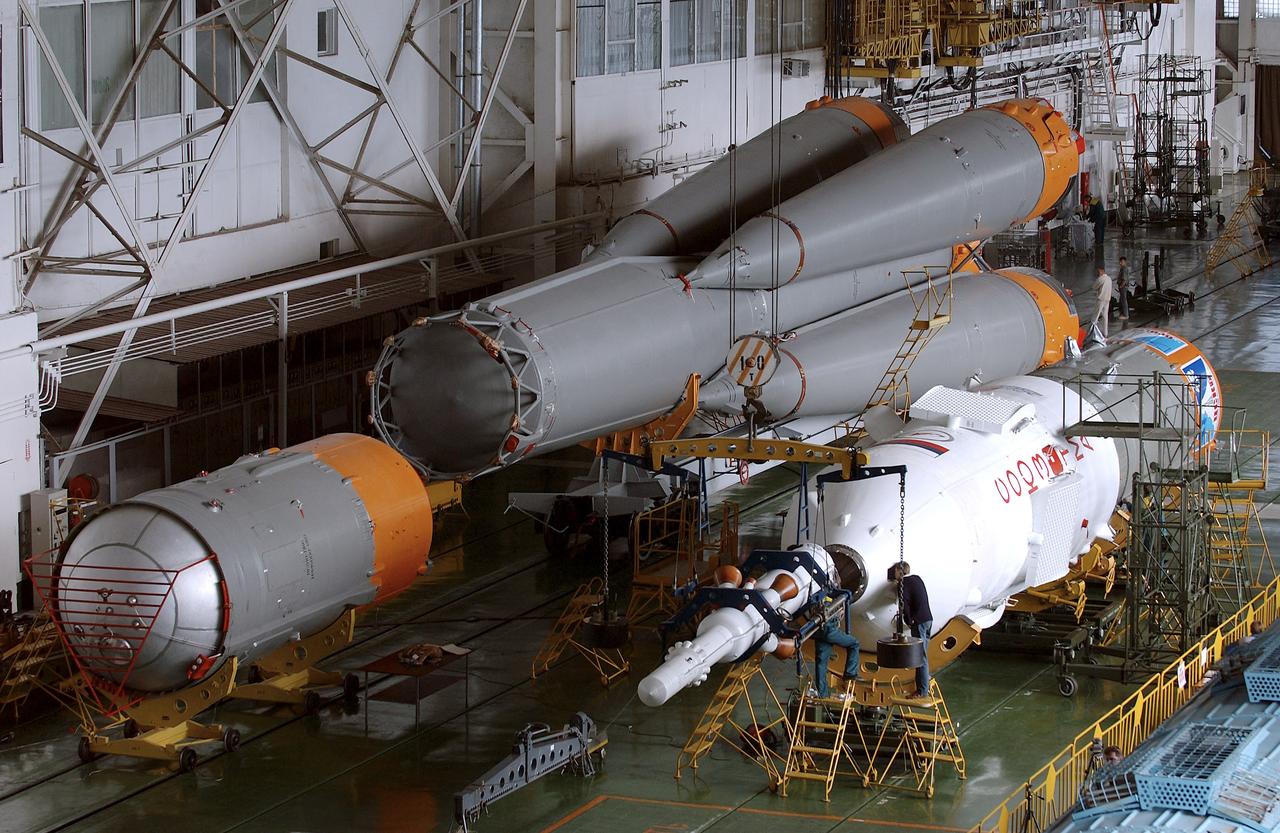 The Soyuz TMA-5 spacecraft is mated to its booster rocket in a processing hangar at the Baikonur Cosmodrome in Kazakhstan Monday, October 11, 2004, in preparation for its rollout to the launch pad October 12 and its liftoff October 14 to carry Expedition 10 Commander and NASA Science Officer Leroy Chiao, Flight Engineer and Soyuz Commander Salizhan Sharipov and Russian Space Forces cosmonaut Yuri Shargin to the International Space Station.  Photo Credit: (NASA/Bill Ingalls)