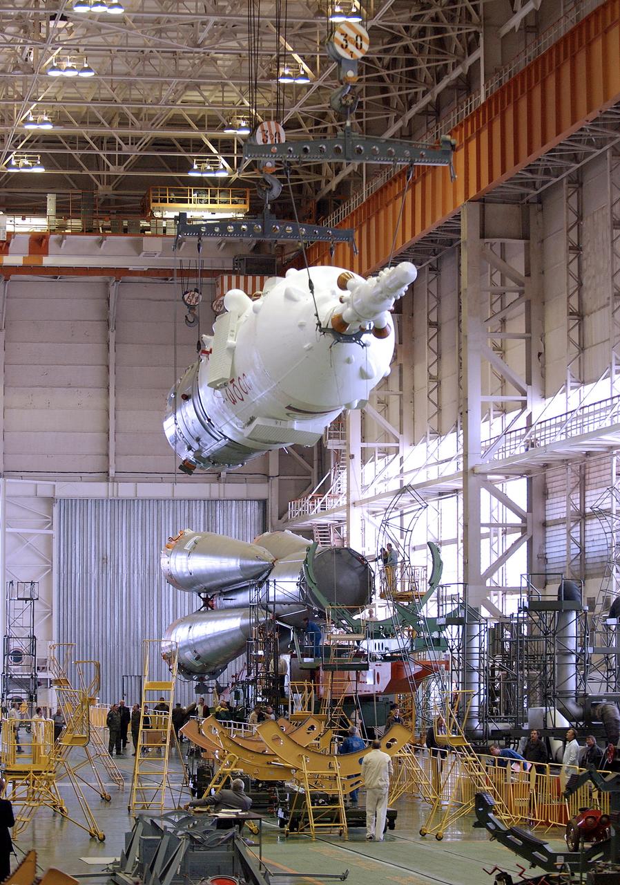 The Soyuz TMA-5 spacecraft is mated to its booster rocket in a processing hangar at the Baikonur Cosmodrome in Kazakhstan Monday, October 11, 2004, in preparation for its rollout to the launch pad October 12 and its liftoff October 14 to carry Expedition 10 Commander and NASA Science Officer Leroy Chiao, Flight Engineer and Soyuz Commander Salizhan Sharipov and Russian Space Forces cosmonaut Yuri Shargin to the International Space Station.  Photo Credit: (NASA/Bill Ingalls)