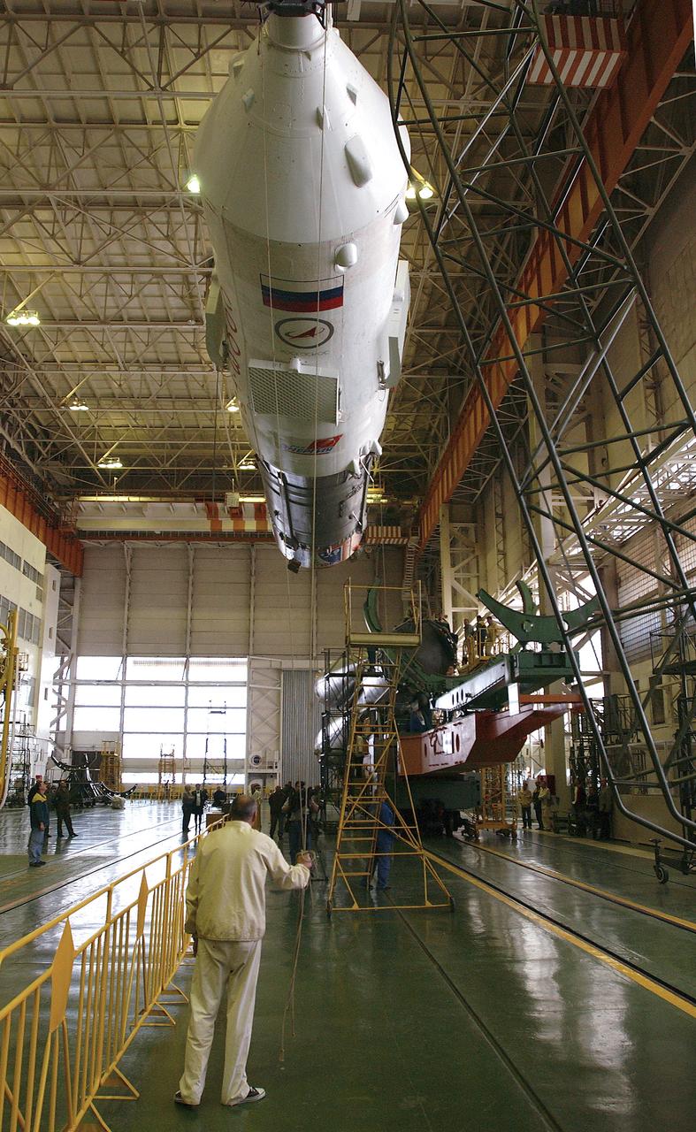 The Soyuz TMA-5 spacecraft is mated to its booster rocket in a processing hangar at the Baikonur Cosmodrome in Kazakhstan Monday, October 11, 2004, in preparation for its rollout to the launch pad October 12 and its liftoff October 14 to carry Expedition 10 Commander and NASA Science Officer Leroy Chiao, Flight Engineer and Soyuz Commander Salizhan Sharipov and Russian Space Forces cosmonaut Yuri Shargin to the International Space Station.  Photo Credit: (NASA/Bill Ingalls)