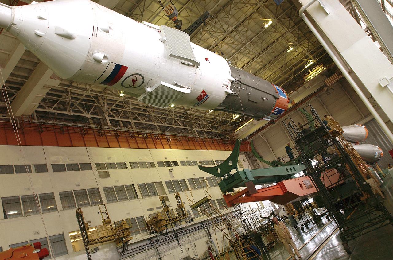 The Soyuz TMA-5 spacecraft is mated to its booster rocket in a processing hangar at the Baikonur Cosmodrome in Kazakhstan Monday, October 11, 2004, in preparation for its rollout to the launch pad October 12 and its liftoff October 14 to carry Expedition 10 Commander and NASA Science Officer Leroy Chiao, Flight Engineer and Soyuz Commander Salizhan Sharipov and Russian Space Forces cosmonaut Yuri Shargin to the International Space Station.  Photo Credit: (NASA/Bill Ingalls)
