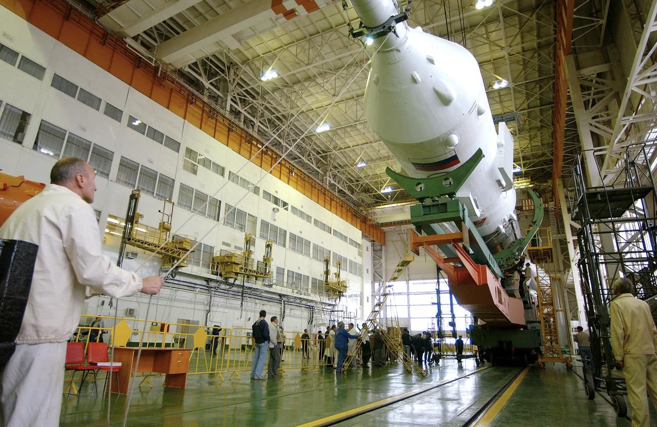 The Soyuz TMA-5 spacecraft is mated to its booster rocket in a processing hangar at the Baikonur Cosmodrome in Kazakhstan Monday, October 11, 2004, in preparation for its rollout to the launch pad October 12 and its liftoff October 14 to carry Expedition 10 Commander and NASA Science Officer Leroy Chiao, Flight Engineer and Soyuz Commander Salizhan Sharipov and Russian Space Forces cosmonaut Yuri Shargin to the International Space Station.  Photo Credit: (NASA/Bill Ingalls)