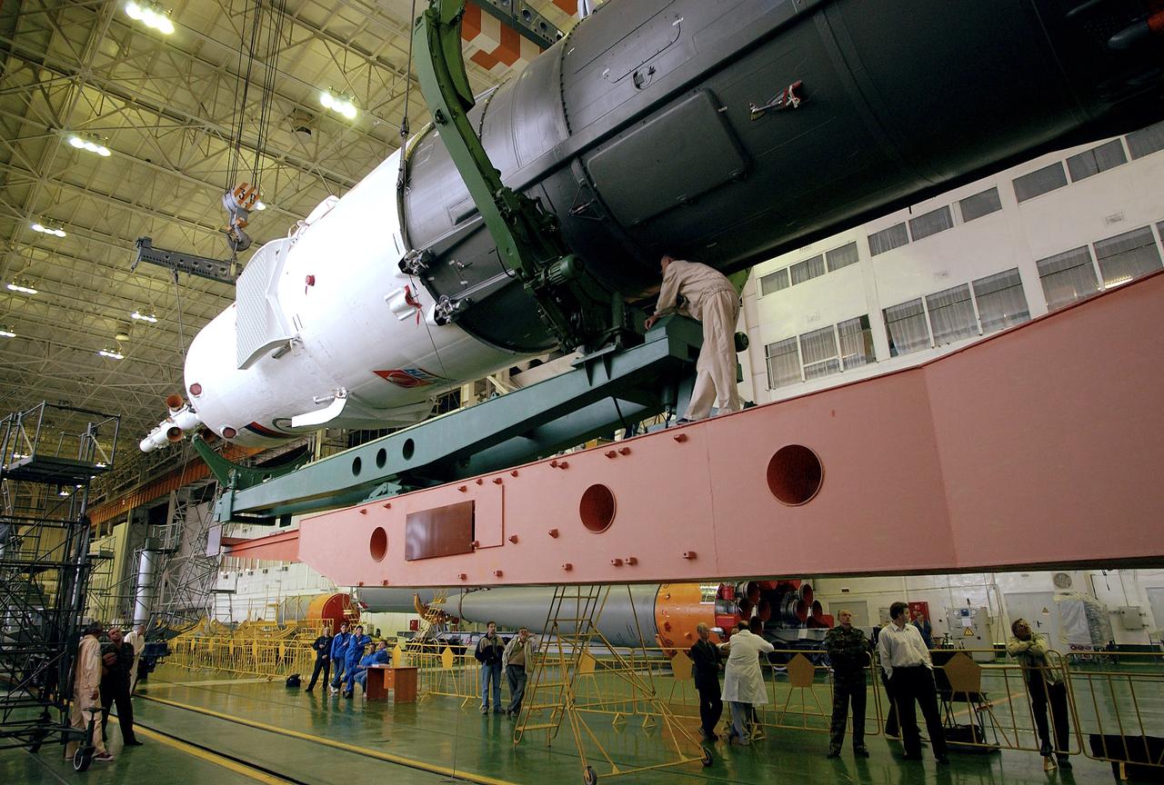 The Soyuz TMA-5 spacecraft is mated to its booster rocket in a processing hangar at the Baikonur Cosmodrome in Kazakhstan Monday, October 11, 2004, in preparation for its rollout to the launch pad October 12 and its liftoff October 14 to carry Expedition 10 Commander and NASA Science Officer Leroy Chiao, Flight Engineer and Soyuz Commander Salizhan Sharipov and Russian Space Forces cosmonaut Yuri Shargin to the International Space Station.  Photo Credit: (NASA/Bill Ingalls)