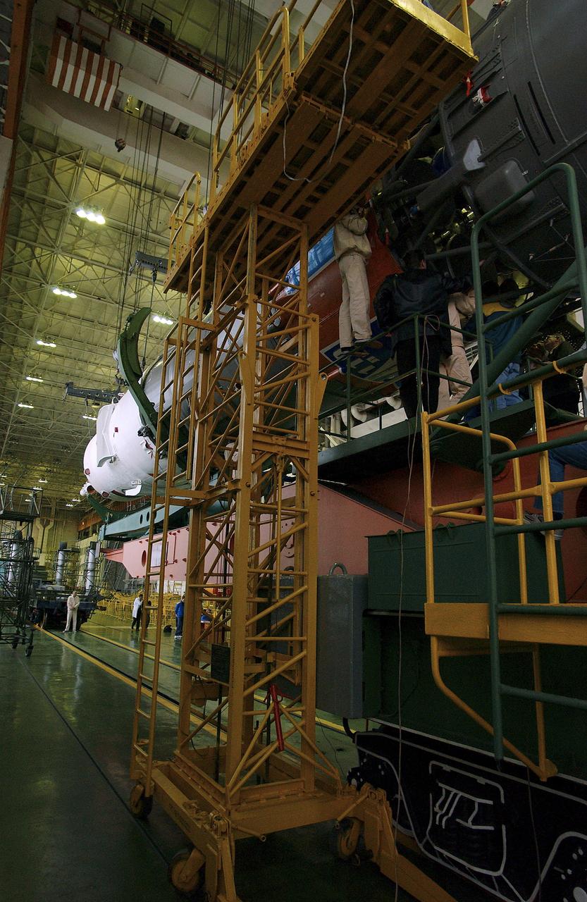 The Soyuz TMA-5 spacecraft is mated to its booster rocket in a processing hangar at the Baikonur Cosmodrome in Kazakhstan Monday, October 11, 2004, in preparation for its rollout to the launch pad October 12 and its liftoff October 14 to carry Expedition 10 Commander and NASA Science Officer Leroy Chiao, Flight Engineer and Soyuz Commander Salizhan Sharipov and Russian Space Forces cosmonaut Yuri Shargin to the International Space Station.  Photo Credit: (NASA/Bill Ingalls)
