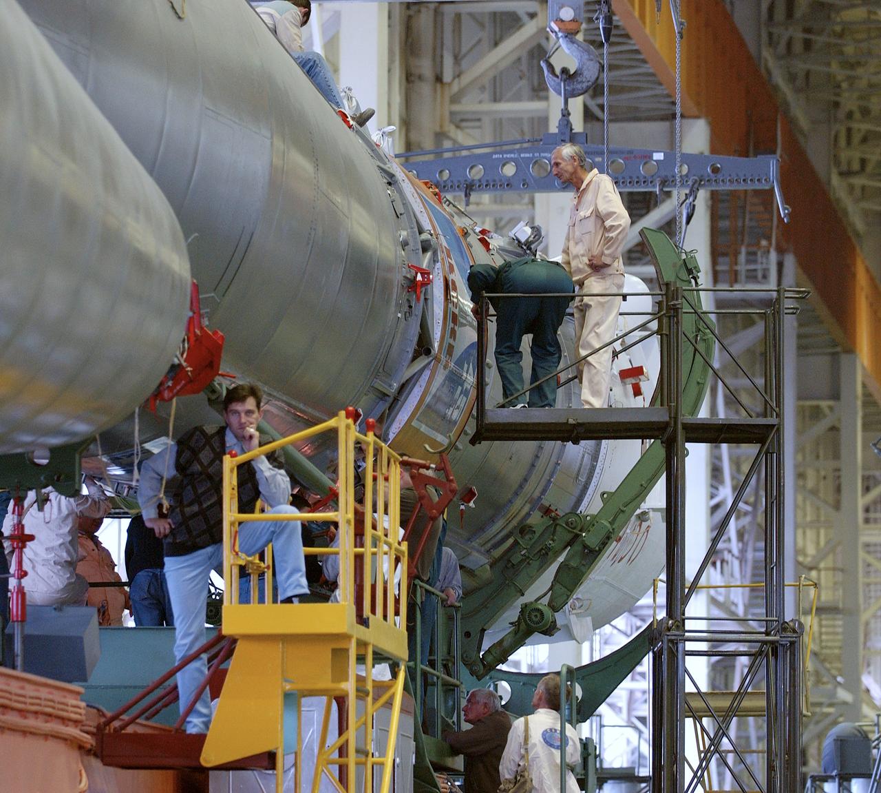 The Soyuz TMA-5 spacecraft is mated to its booster rocket in a processing hangar at the Baikonur Cosmodrome in Kazakhstan Monday, October 11, 2004, in preparation for its rollout to the launch pad October 12 and its liftoff October 14 to carry Expedition 10 Commander and NASA Science Officer Leroy Chiao, Flight Engineer and Soyuz Commander Salizhan Sharipov and Russian Space Forces cosmonaut Yuri Shargin to the International Space Station.  Photo Credit: (NASA/Bill Ingalls)