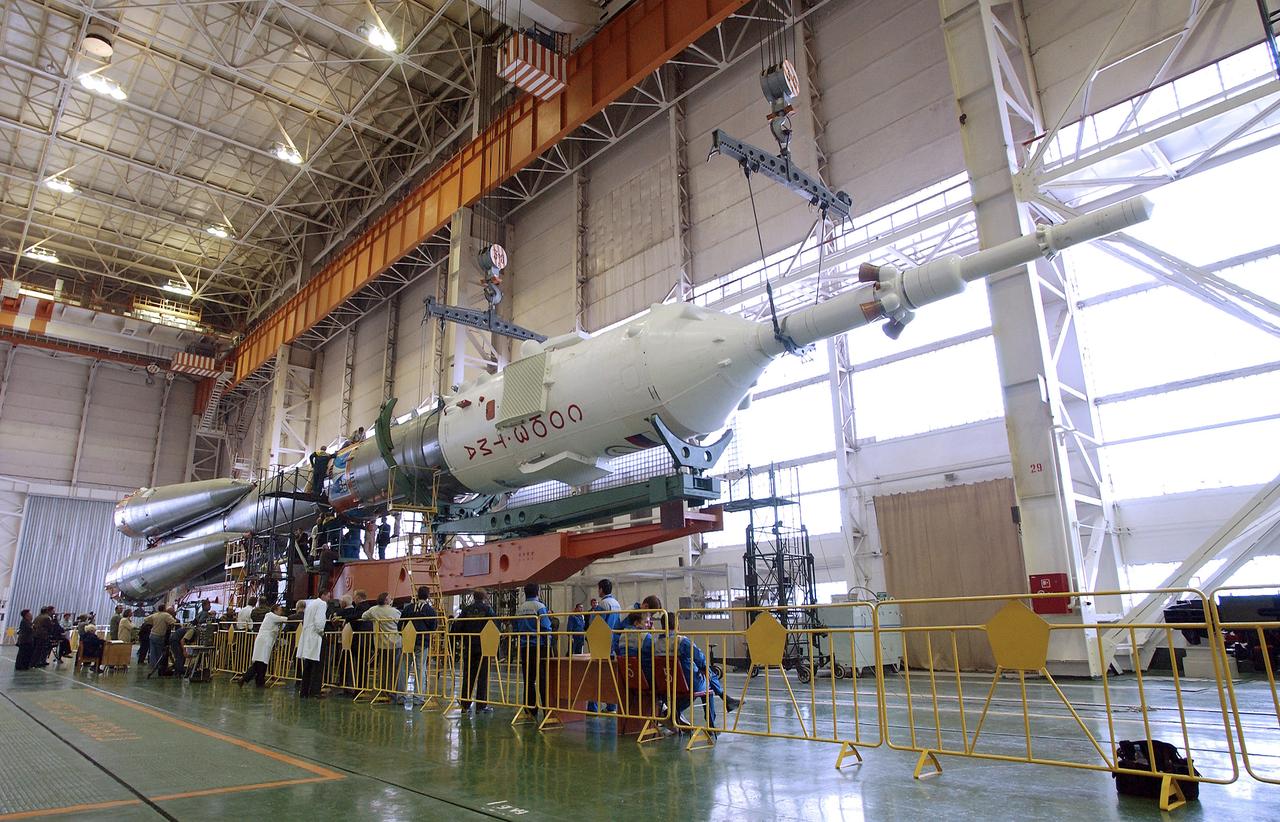 The Soyuz TMA-5 spacecraft is mated to its booster rocket in a processing hangar at the Baikonur Cosmodrome in Kazakhstan Monday, October 11, 2004, in preparation for its rollout to the launch pad October 12 and its liftoff October 14 to carry Expedition 10 Commander and NASA Science Officer Leroy Chiao, Flight Engineer and Soyuz Commander Salizhan Sharipov and Russian Space Forces cosmonaut Yuri Shargin to the International Space Station.  Photo Credit: (NASA/Bill Ingalls)