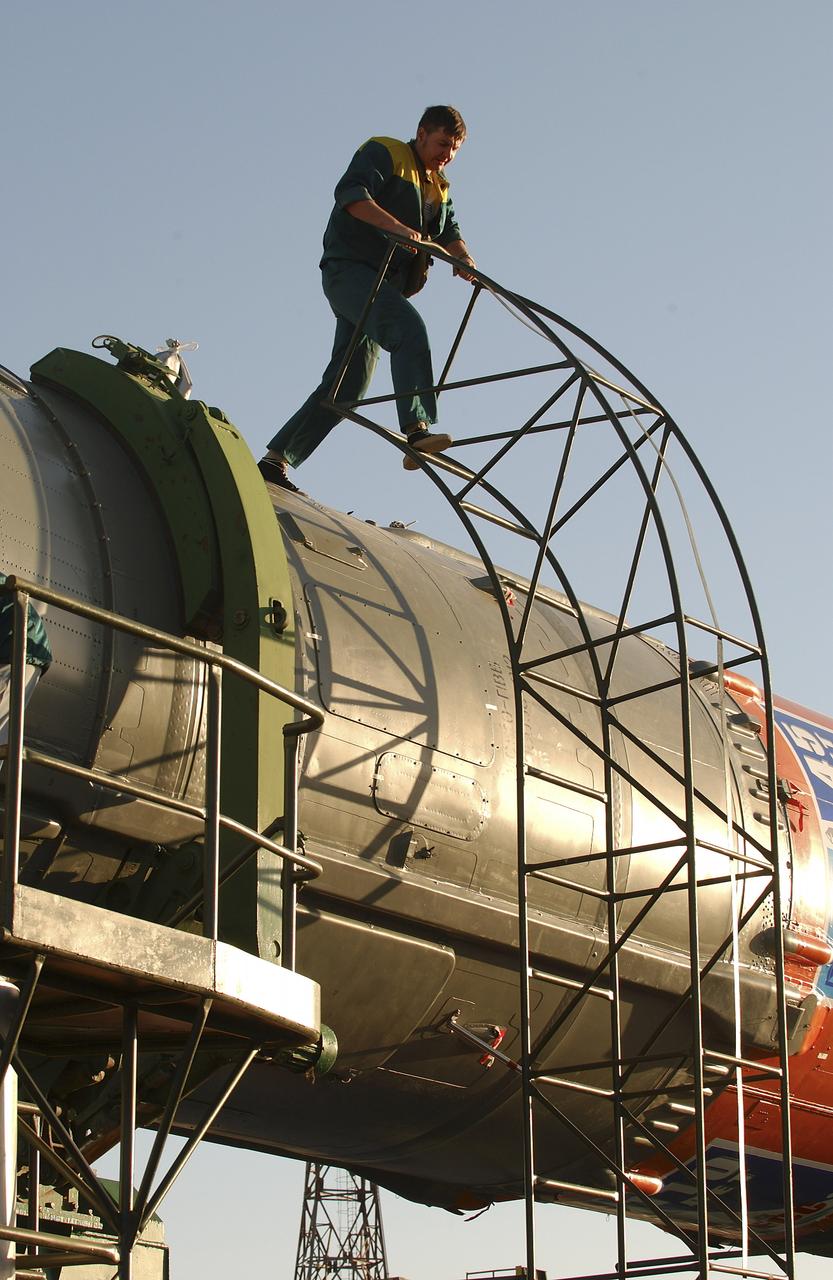 The Soyuz TMA-5 vehicle rolled to its launch pad at the Baikonur Cosmodrome in Kazakhstan, Tuesday, October 12, 2004, in preparation for its launch October 14 to send Expedition 10 Commander and NASA Science Officer Leroy Chiao, Flight Engineer and Soyuz Commander Salizhan Sharipov and Russian Space Forces cosmonaut Yuri Shargin to the International Space Station. Chiao and Sharipov will replace the Expedition 9 crew of Gennady Padalka and Mike Fincke, while Shargin will conduct eight days of scientific experiments. He will return to earth with the Expedition 9 crew October 24. Photo Credit: (NASA/Bill Ingalls)