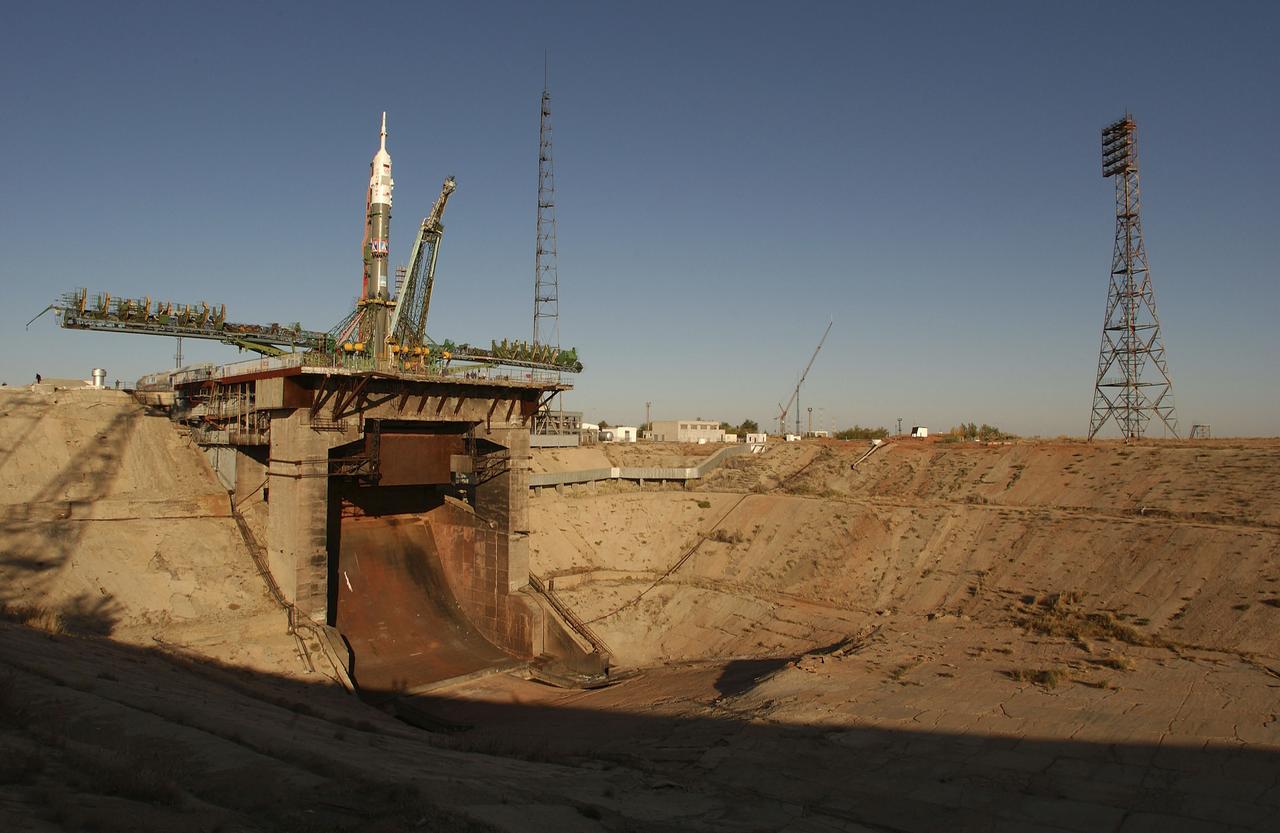 The Soyuz TMA-5 vehicle rolled to its launch pad at the Baikonur Cosmodrome in Kazakhstan, Tuesday, October 12, 2004, in preparation for its launch October 14 to send Expedition 10 Commander and NASA Science Officer Leroy Chiao, Flight Engineer and Soyuz Commander Salizhan Sharipov and Russian Space Forces cosmonaut Yuri Shargin to the International Space Station. Chiao and Sharipov will replace the Expedition 9 crew of Gennady Padalka and Mike Fincke, while Shargin will conduct eight days of scientific experiments. He will return to earth with the Expedition 9 crew October 24. Photo Credit: (NASA/Bill Ingalls)
