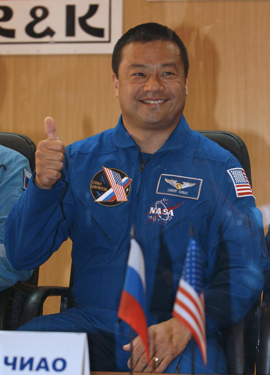 Expedition 10 Commander Leroy Chiao gives the thumbs up to the press from behind glass one day prior to the scheduled launch of the Soyuz TMA-5 spacecraft to the International Space Station, Wednesday, Oct. 13, 2004. The crew docked to the Station on October 16, and Chiao and Sharipov will replace the current Station crewmembers, Gennady Padalka and Mike Fincke, who will return to Earth October 24 with Shargin.  Photo Credit: (NASA/Bill Ingalls)