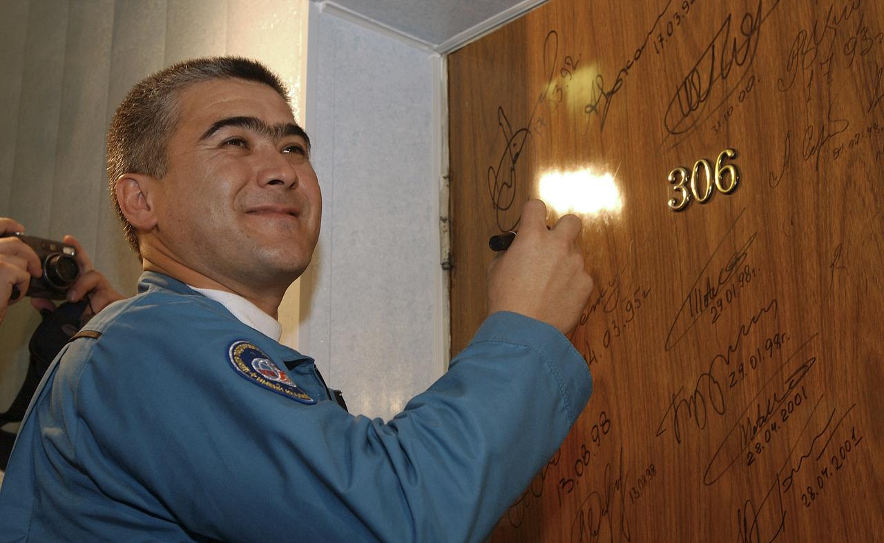 Expedition 10 Soyuz Commander Salizhan Sharipov prepares to do the traditional door signing prior to his departure from the Cosmonaut Hotel for launch, Thursday, Oct. 14, 2004, in Baikonur, Kazakhstan.  The crew will dock to the International Space Station on October 16, and Chiao and Sharipov will replace the current station crewmembers, Gennady Padalka and Mike Fincke, who will return to Earth October 24 with Shargin.  Photo Credit: (NASA/Bill Ingalls)
