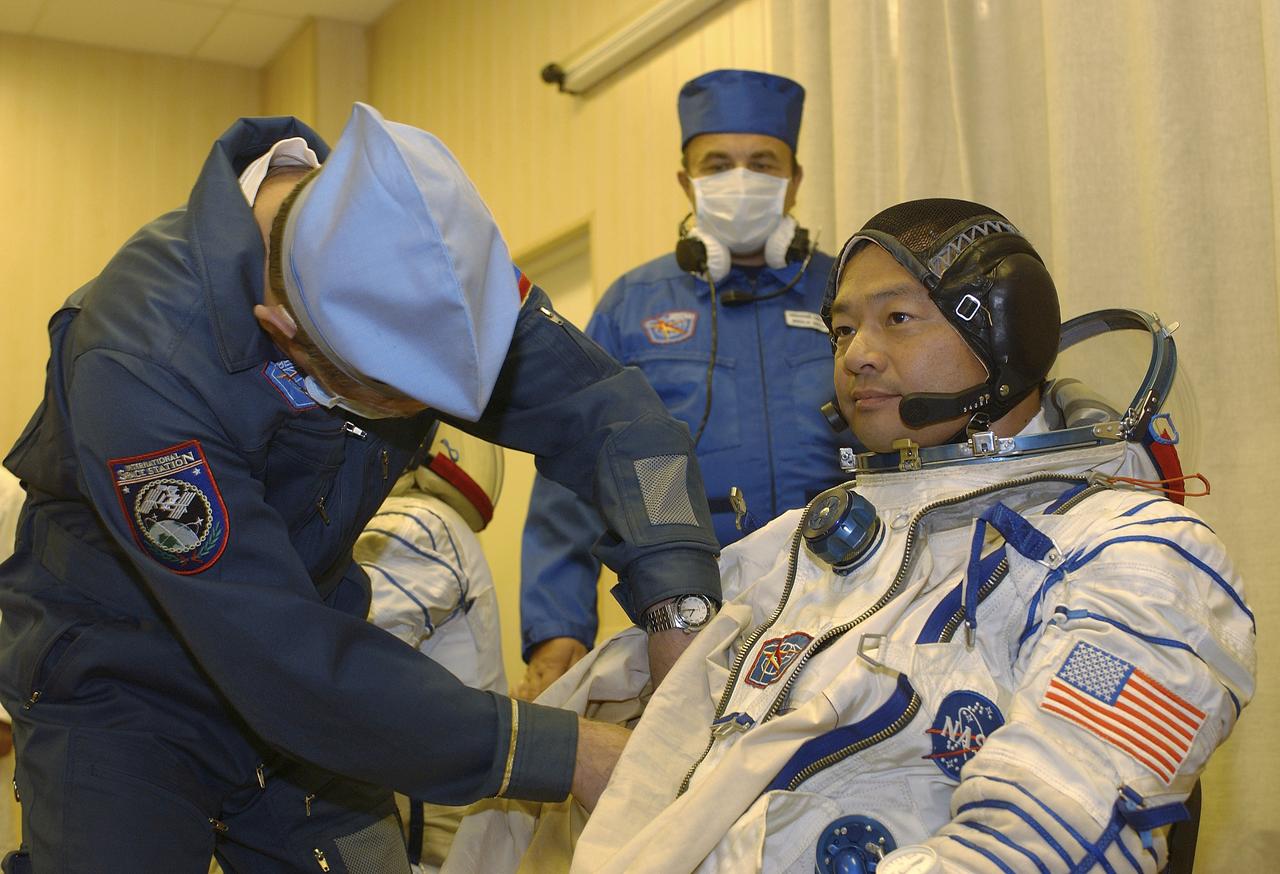 Expedition 10 Commander Leroy Chiao dons his flight suit prior to launch on board the Soyuz TMA-5 spacecraft to the International Space Station, Thursday, Oct. 14, in Baikonur, Kazakhstan.  The crew will dock to the Station on October 16, and Chiao and Sharipov will replace the current Station crew members, Gennady Padalka and Mike Fincke, who will return to Earth October 24 with Shargin.  Photo Credit: (NASA/Bill Ingalls)