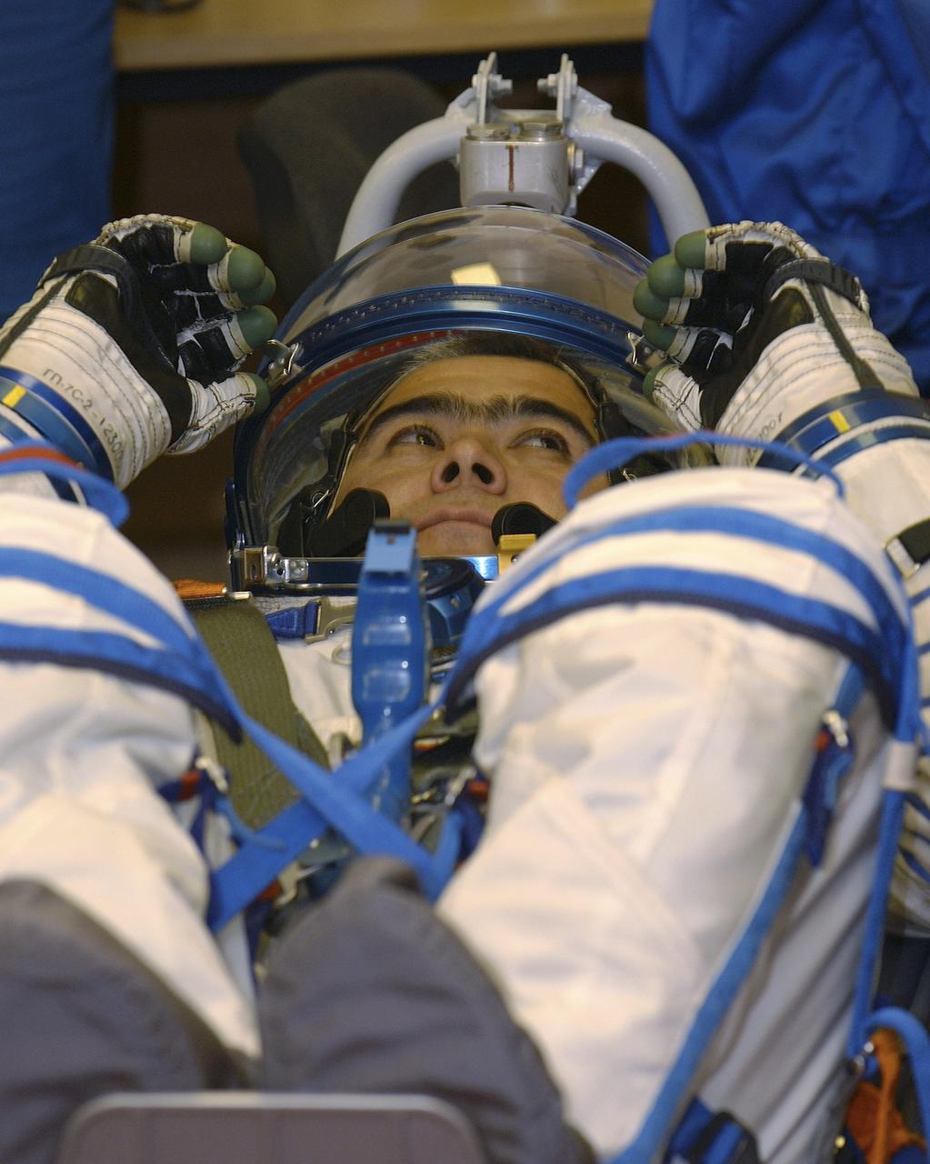 Expedition 10 Soyuz Commander Salizhan Sharipov dons his flight suit prior to launch on board the Soyuz TMA-5 spacecraft to the International Space Station, Thursday, Oct. 14, in Baikonur, Kazakhstan.  The crew will dock to the Station on October 16, and Chiao and Sharipov will replace the current Station crew members, Gennady Padalka and Mike Fincke, who will return to Earth October 24 with Shargin.  Photo Credit: (NASA/Bill Ingalls)