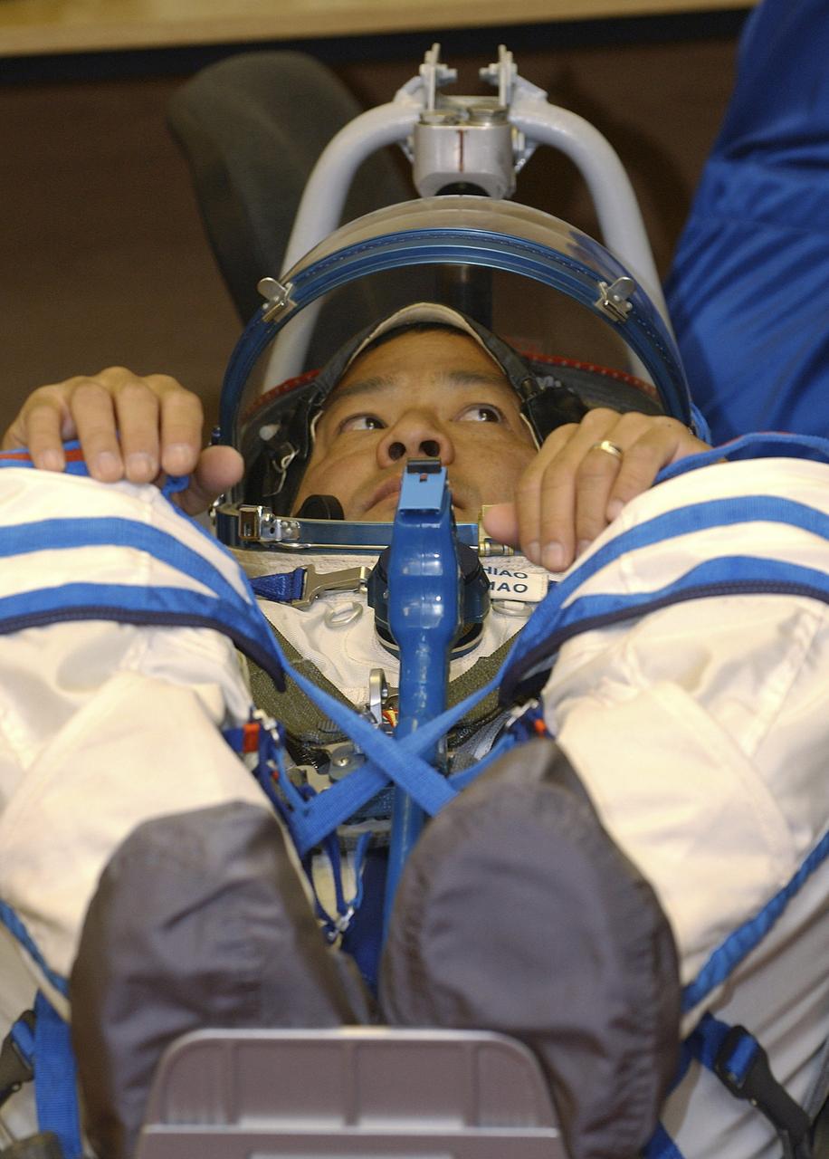 Expedition 10 Commander Leroy Chiao dons his flight suit prior to launch on board the Soyuz TMA-5 spacecraft to the International Space Station, Thursday, Oct. 14, in Baikonur, Kazakhstan.  The crew will dock to the Station on October 16, and Chiao and Sharipov will replace the current Station crew members, Gennady Padalka and Mike Fincke, who will return to Earth October 24 with Shargin.  Photo Credit: (NASA/Bill Ingalls)