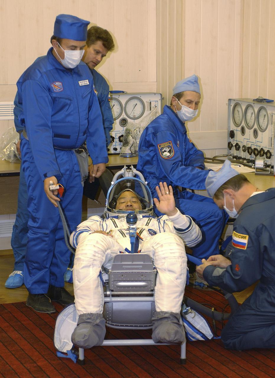 Expedition 10 Commander Leroy Chiao dons his flight suit prior to launch on board the Soyuz TMA-5 spacecraft to the International Space Station, Thursday, Oct. 14, in Baikonur, Kazakhstan. The crew will dock to the Station on October 16, and Chiao and Sharipov will replace the current Station crew members, Gennady Padalka and Mike Fincke, who will return to Earth October 24 with Shargin. Photo Credit: (NASA/Bill Ingalls)