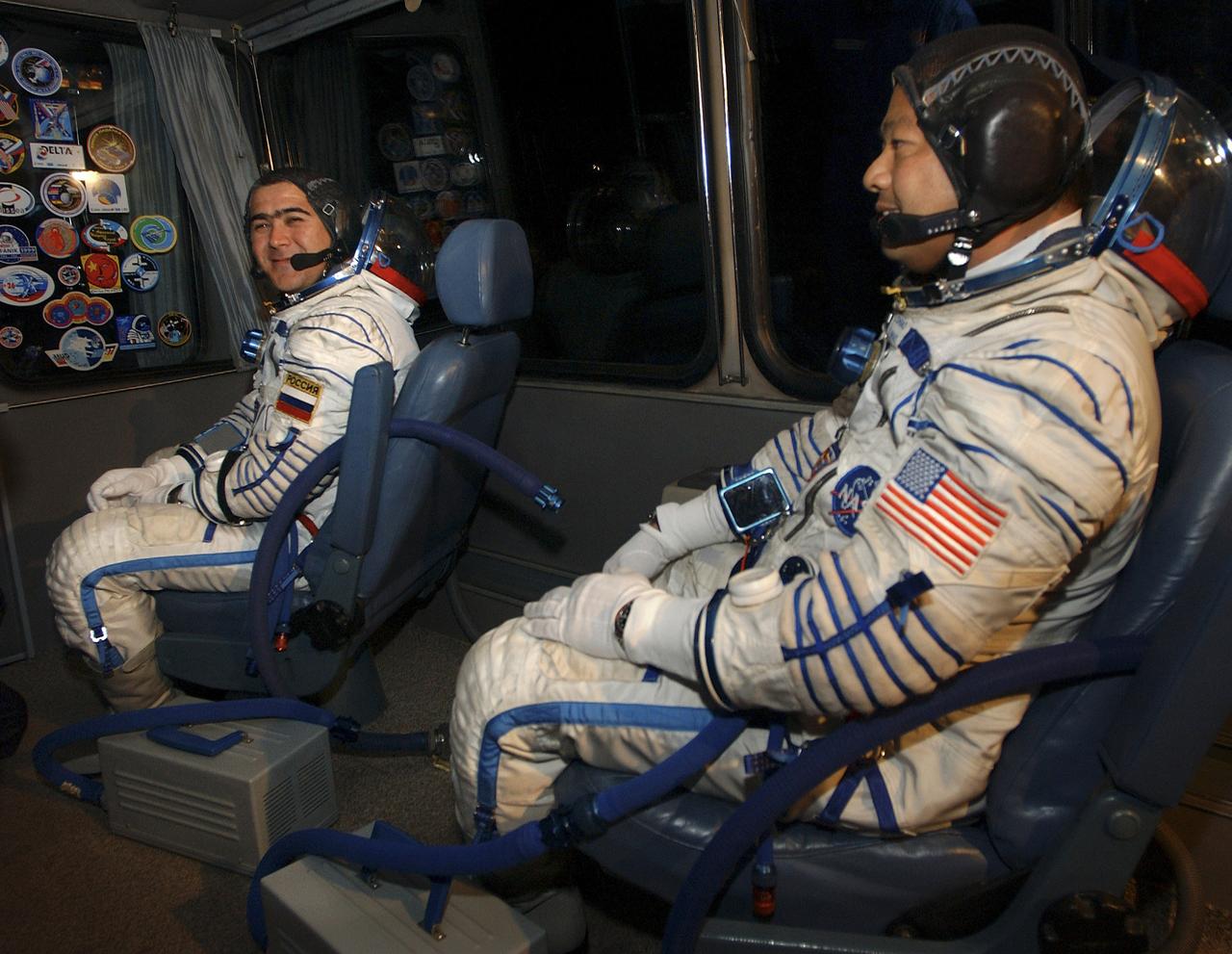 Expedition 10 Commander and NASA Science Officer Leroy Chiao, right and Flight Engineer and Soyuz Commander Salizhan Sharipov during the ride from the suit up facility at the Baikonur Cosmodrome in Kazakhstan to the launch pad as they prepare for their liftoff to the International Space Station, Thursday, Oct. 14, 2004.  Their Soyuz TMA-5 vehicle will blast off at 9:06 a.m. Baikonur time (306 GMT) to begin the two-day trip to the ISS.  Photo Credit: (NASA/Bill Ingalls)