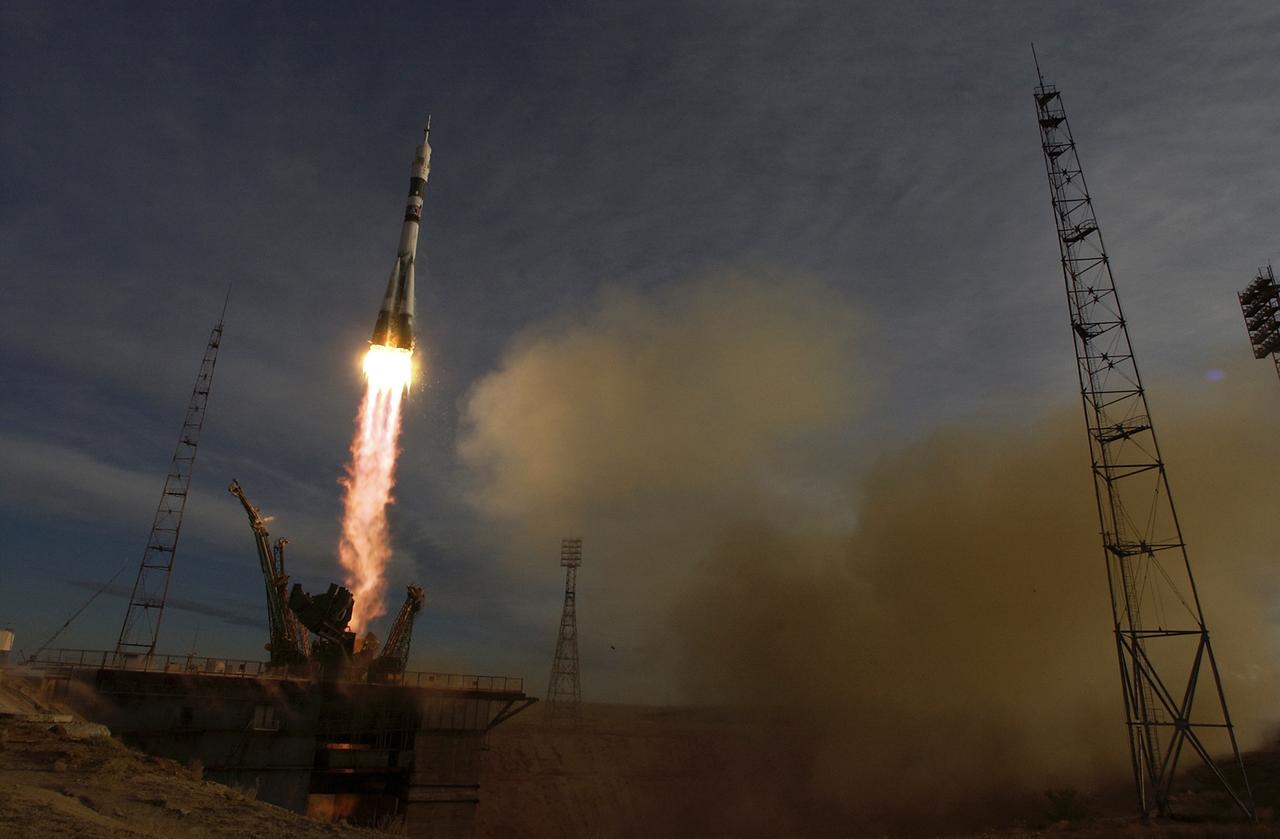 The Soyuz TMA-5 spacecraft blasts off from the Baikonur Cosmodrome in Kazakhstan, Thursday, October 14, 2004, carrying Expedition 10 Commander Leroy Chiao, Flight Engineer and Soyuz Commander Salizhan Sharipov and Russian Space Forces cosmonaut Yuri Shargin to the International Space Station.  The crew will dock to the Station on October 16, and Chiao and Sharipov will replace the current Station crew members, Gennady Padalka and Mike Fincke, who will return to Earth October 24 with Shargin.  Photo Credit: (NASA/Bill Ingalls)