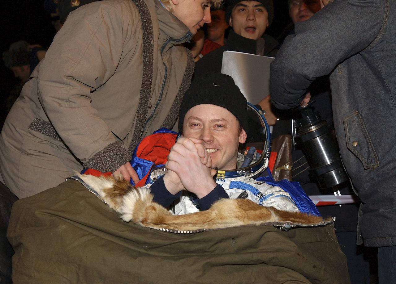 Expedition 9 Flight Engineer Michael Fincke shows his happiness with the successful landing in the Syouz spacecraft with fellow crew members, Expedition 9 Commander Gennady Padalka and Russian Space Forces cosmonaut Yuri Shargin. The crew landed in their Soyuz capsule approximately 85 kilometers northeast of Arkalyk in northern Kazakhstan, Sunday, October 24, 2004.  Photo Credit: (NASA/Bill Ingalls)