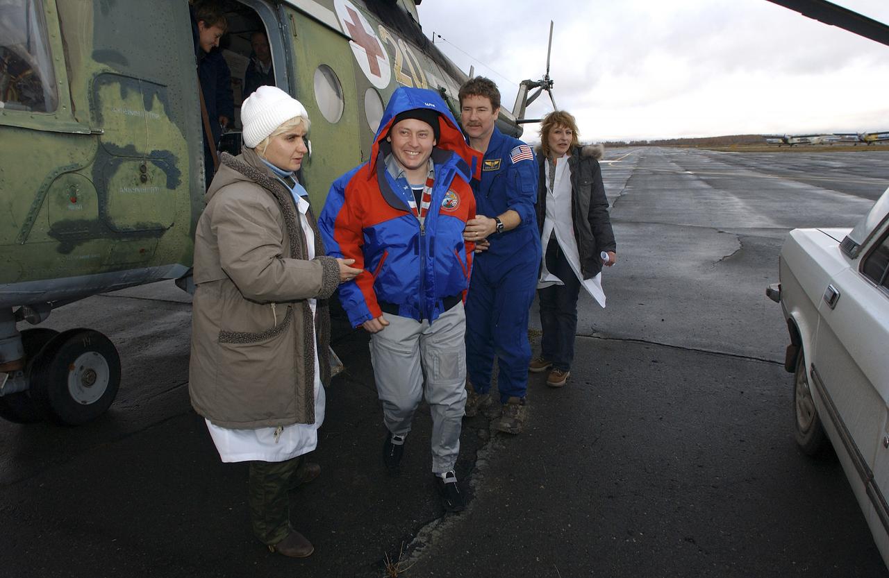 Expedition 9 Flight Engineer Michael Fincke exits the Russian search and rescue helicopter in Kustanay, Kazakhstan after the 2 hour flight from the landing site, Sunday, October 24, 2004. Photo Credit: (NASA/Bill Ingalls)