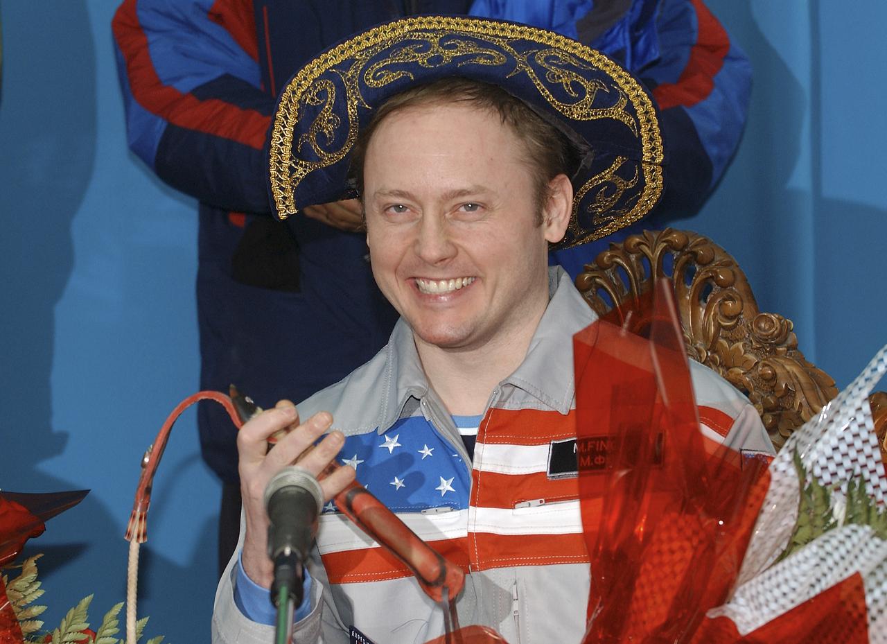 Expedition 9 Flight Engineer Michael Fincke is given traditional Kazak gifts during a press conference at the Kustanay airport in Kazakhstan, Sunday, October 24, 2004. Photo Credit: (NASA/Bill Ingalls)