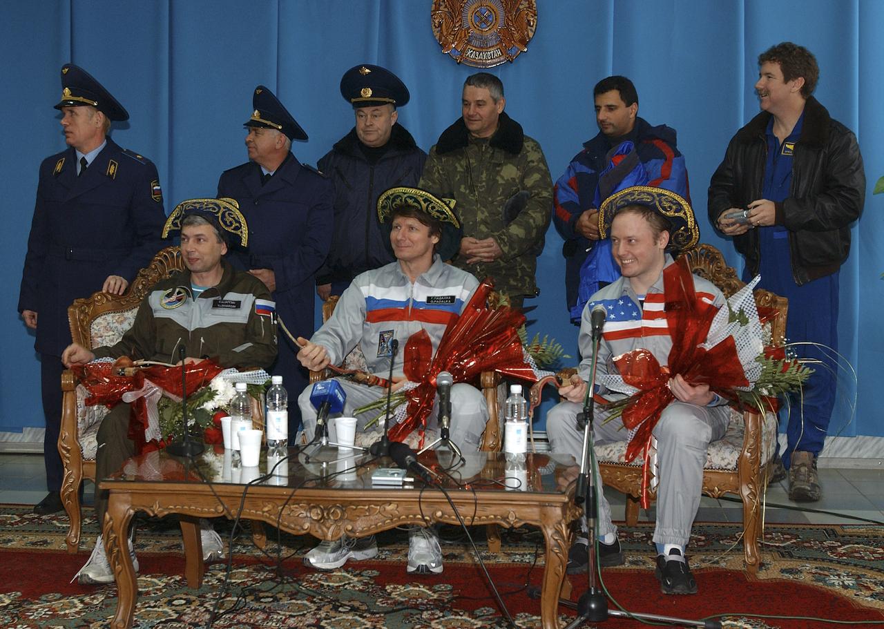 Russian Space Forces cosmonaut Yuri Shargin, left, Expedition 9 Commander Gennady Padalka and Expedition 9 Flight Engineer Michael Fincke, right, pose for photos after receiving gifts at a press conference at the airport in Kustanay, Kazakhstan, Sunday, October 24, 2004. Photo Credit: (NASA/Bill Ingalls)