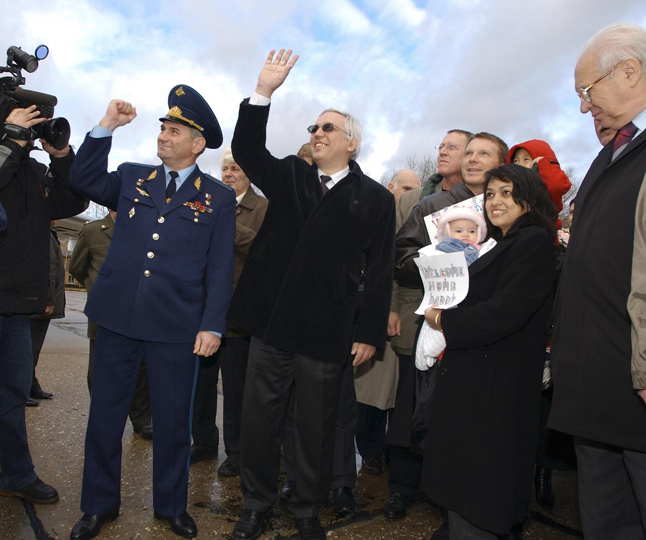 Russian Federal Space Agency Deputy General-Director Nikolai Moiseev, center, Renita Fincke, wife of Expedition 9 Flight Engineer Michael Fincke, second from right with baby, and other officials and family members celebrate the return of the Expedition 9 crew to Star City, Russia after their Soyuz capsule landed safely approximately 85 kilometers northeast of Arkalyk in northern Kazakhstan, Sunday, October 24, 2004. Photo Credit: (NASA/Bill Ingalls)