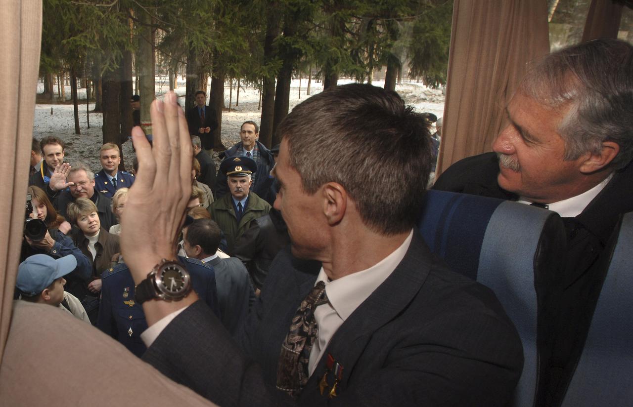 Expedition 11 Commander Sergei Krikalev, left, Flight Engineer John Phillips bid farewell as they depart the Gagarin Cosmonaut Training Center training base, Saturday, April 9, 2005, in Star City, Russia to travel to the Baikonur Cosmodrome in Kazakhstan for final pre-launch preparations. Krikalev, Phillips along with European Space Agency Astronaut Roberto Vittori will launch April 15 on a Soyuz TMA-6 spacecraft to the International Space Station. Krikalev and Phillips will spend six months in space and greet the first Shuttle crew to fly in more than two years when it arrives at the Station, while Vittori spends eight days on the Station under a commercial contract between ESA and the Russian Federal Space Agency. Photo Credit: (NASA/Bill Ingalls)