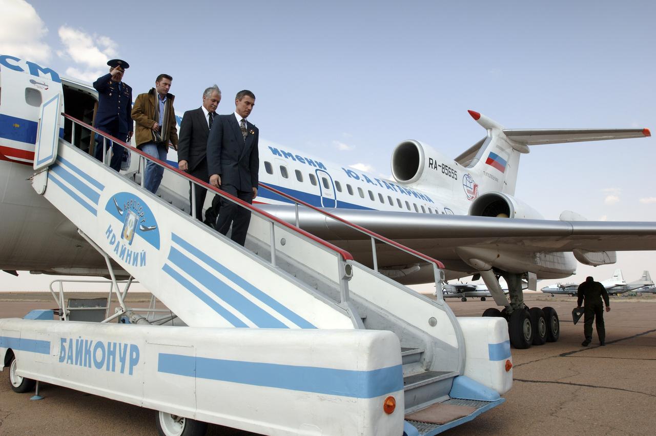 Expedition 11 Commander Sergei Krikalev, front, Flight Engineer John Phillips and European Space Agency astronaut Roberto Vittori, second from rear, arrive at the Baikonur Cosmodrome in Baikonur, Kazakhstan, Saturday, April 9, 2005, for pre-launch preparations. Krikalev, Phillips and Vittori will launch April 15 on a Soyuz TMA-6 spacecraft to the International Space Station. Krikalev and Phillips will spend six months in space and greet the first Shuttle crew to fly in more than two years when it arrives at the Station, while Vittori spends eight days on the Station under a commercial contract between ESA and the Russian Federal Space Agency. Photo Credit: (NASA/Bill Ingalls)