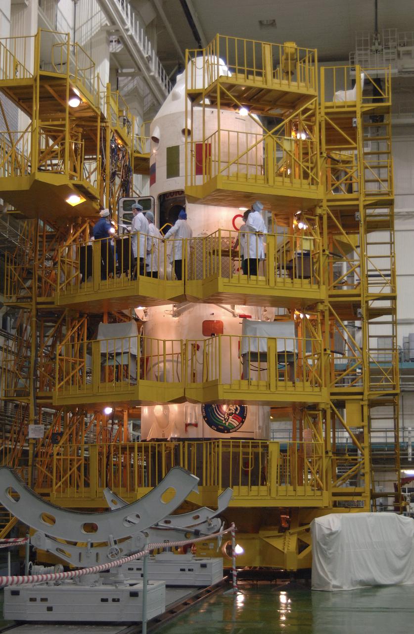 Russian space officials, along with Expediton 11 crew members Commander Sergei Krikalev, Flight Engineer John Phillips and European Space Agency astronaut Roberto Vittori discuss the checkout of the Soyuz TMA-6 spacecraft during preparations for launch, Sunday, April 10, 2005, at the Baikonur Cosmodrome in Baikonur, Kazakhstan. Krikalev, Phillips and Vittori will launch April 15 on the Soyuz TMA-6 spacecraft to the International Space Station. Krikalev and Phillips will spend six months in space and greet the first Shuttle crew to fly in more than two years when it arrives at the station, while Vittori spends eight days on the station under a commercial contract between ESA and the Russian Federal Space Agency. Photo Credit: (NASA/Bill Ingalls)