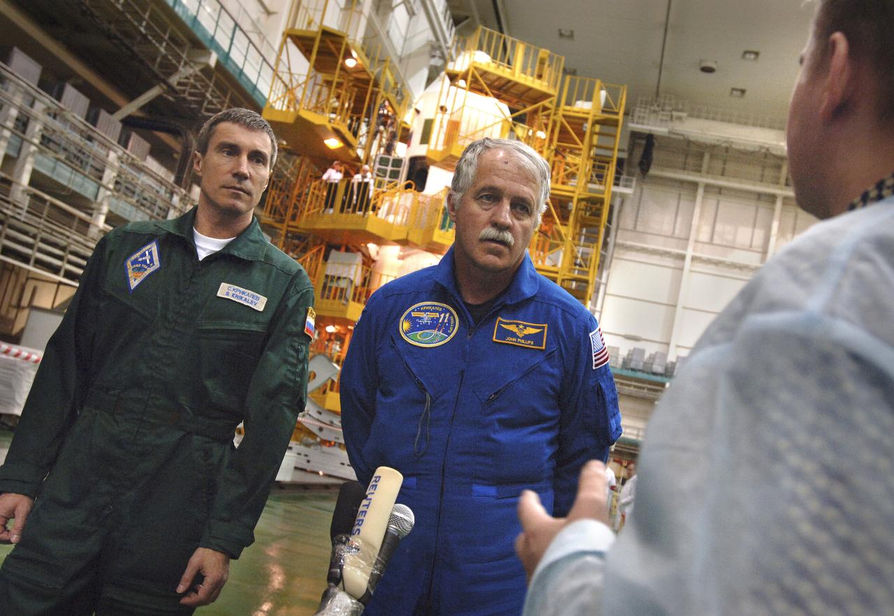 Expedition 11 Commander Sergei Krikalev, left, and Flight Engineer John Phillips discuss the checkout of the Soyuz TMA-6 spacecraft with the press at the Baikonur Cosmodrome in Baikonur, Kazakhstan, Sunday, April 10, 2005, during preparations for their launch to the International Space Station. Krikalev, Phillips and European Space Agency astronaut Roberto Vittori will launch April 15 on the Soyuz TMA-6 spacecraft to the International Space Station. Krikalev and Phillips will spend six months in space and greet the first Shuttle crew to fly in more than two years when it arrives at the station, while Vittori spends eight days on the station under a commercial contract between ESA and the Russian Federal Space Agency. Photo Credit: (NASA/Bill Ingalls)