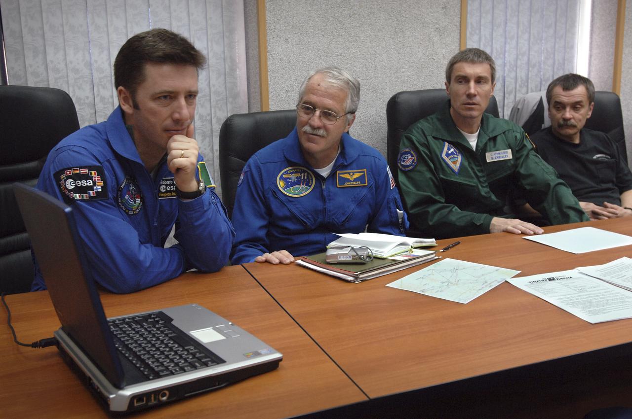 European Space Agency Astronaut Roberto Vittori, of Italy, left, Expedition 11 Flight Engineer John Phillips, Commander Sergei Krikalev and backup, Russian Commander Mikhail Tyurin, right, watch a video about a Soyuz landing at the Cosmonaut Hotel in Baikonur, Kazakhstan, Monday, April 11, 2005, during preparations for the April 15 launch on a Soyuz TMA-6 spacecraft to the International Space Station. Krikalev and Phillips will spend six months in space and greet the first Shuttle crew to fly in more than two years when it arrives at the station, while Vittori spends eight days on the station under a commercial contract between ESA and the Russian Federal Space Agency. Photo Credit: (NASA/Bill Ingalls)