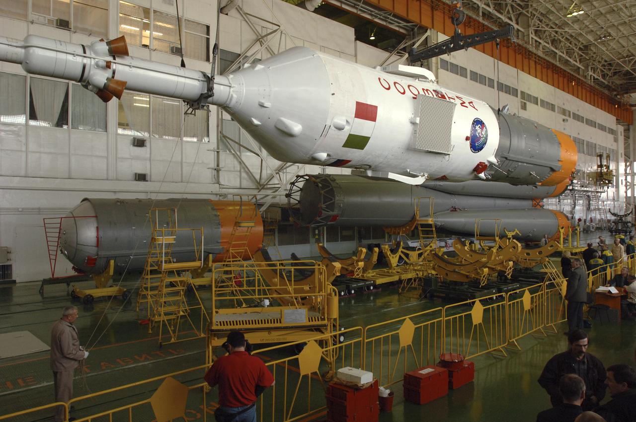 Russian technicians work, Tuesday, April 12, 2005, on mating the Soyuz TMA-6 spacecraft to the booster rocket inside the integration facility at the Baikonur Cosmodrome in Kazakhstan as preparations continued for the April 15 launch of Expedition 11 with Commander Sergei Krikalev, Flight Engineer John Phillips and European Space Agency Astronaut Roberto Vittori, of Italy, to the International Space Station. The rocket mating operation occurred on the 44th anniversary of the launch of Yuri Gagarin from the same complex to become the first human in space. Photo Credit: (NASA/Bill Ingalls)