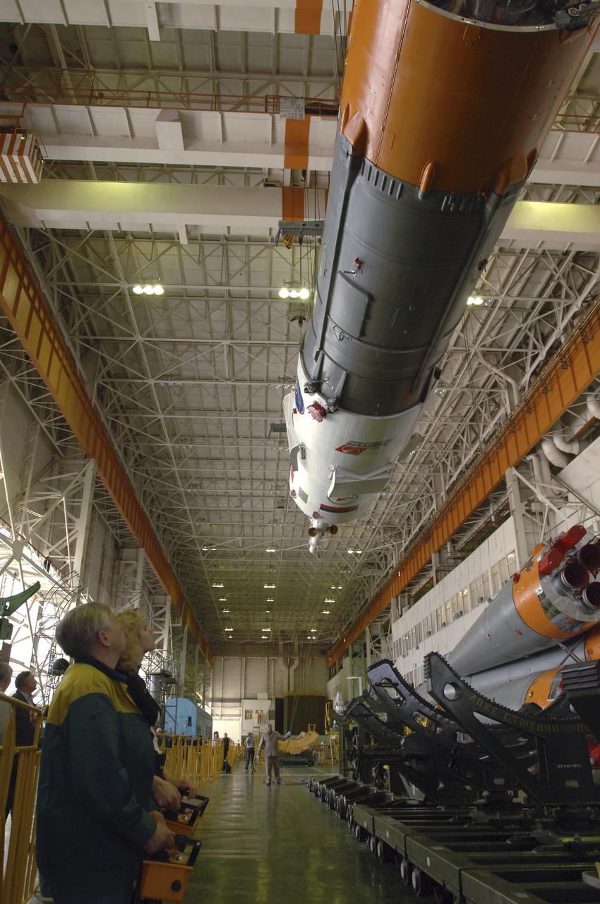 Russian technicians work, Tuesday, April 12, 2005, on mating the Soyuz TMA-6 spacecraft to the booster rocket inside the integration facility at the Baikonur Cosmodrome in Kazakhstan as preparations continued for the April 15 launch of Expedition 11 with Commander Sergei Krikalev, Flight Engineer John Phillips and European Space Agency Astronaut Roberto Vittori, of Italy, to the International Space Station. The rocket mating operation occurred on the 44th anniversary of the launch of Yuri Gagarin from the same complex to become the first human in space. Photo Credit: (NASA/Bill Ingalls)