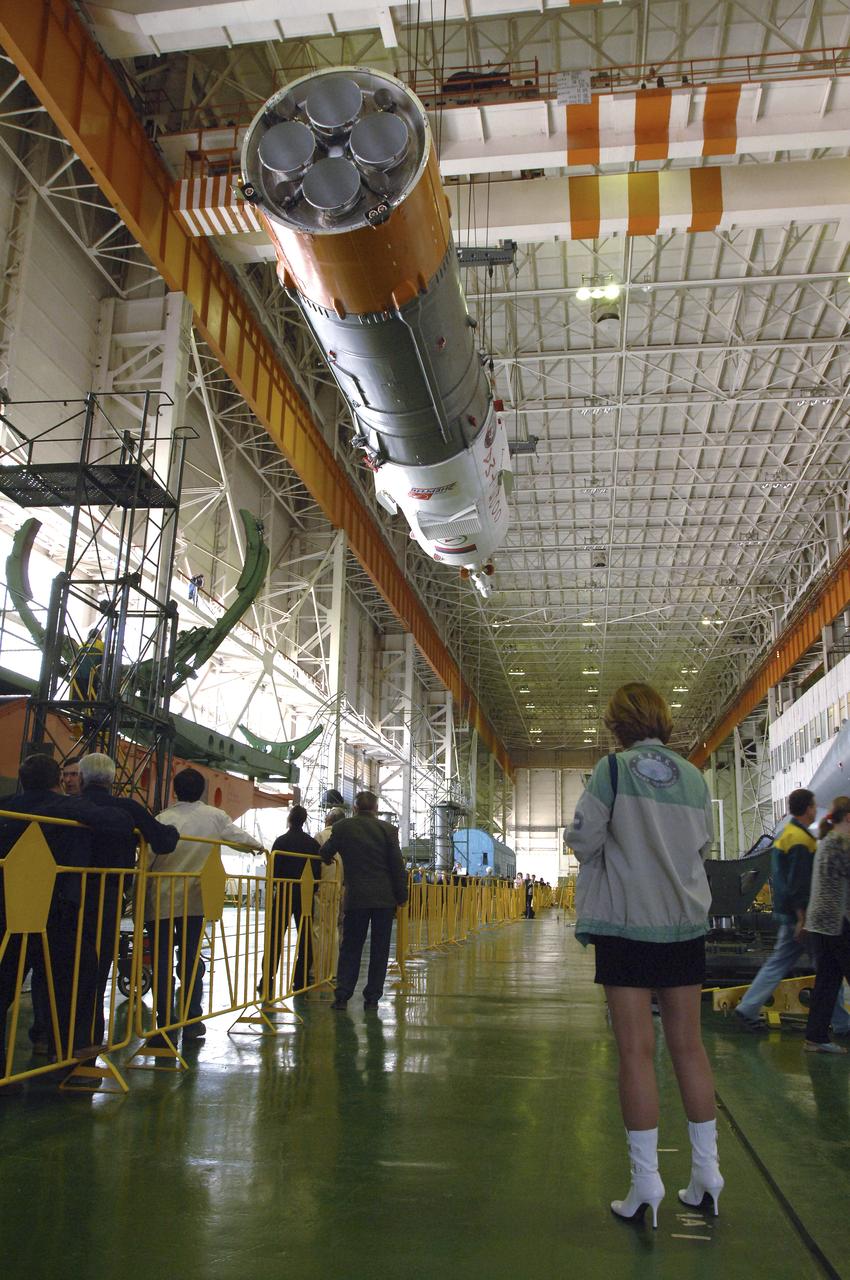 Russian technicians work, Tuesday, April 12, 2005, on mating the Soyuz TMA-6 spacecraft to the booster rocket inside the integration facility at the Baikonur Cosmodrome in Kazakhstan as preparations continued for the April 15 launch of Expedition 11 with Commander Sergei Krikalev, Flight Engineer John Phillips and European Space Agency Astronaut Roberto Vittori, of Italy, to the International Space Station. The rocket mating operation occurred on the 44th anniversary of the launch of Yuri Gagarin from the same complex to become the first human in space. Photo Credit: (NASA/Bill Ingalls)
