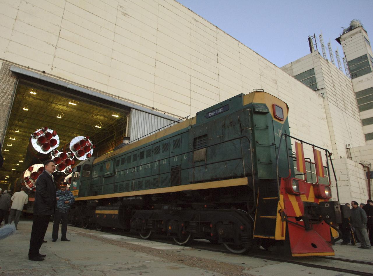 Officials look on as the Soyuz TMA-6 vehicle begins the journey to the launch pad at the Baikonur Cosmodrome in Kazakhstan, Wednesday, April 13, 2005, in preparation for the April 15 launch to send Expedition 11 Commander Sergei Krikalev, Flight Engineer John Phillips and European Space Agency Astronaut Roberto Vittori, of Italy, to the International Space Station. Krikalev and Phillips will spend six months in space and greet the first Shuttle crew to fly in more than two years when it arrives at the station, while Vittori spends eight days on the station under a commercial contract between ESA and the Russian Federal Space Agency. Photo Credit: (NASA/Bill Ingalls)
