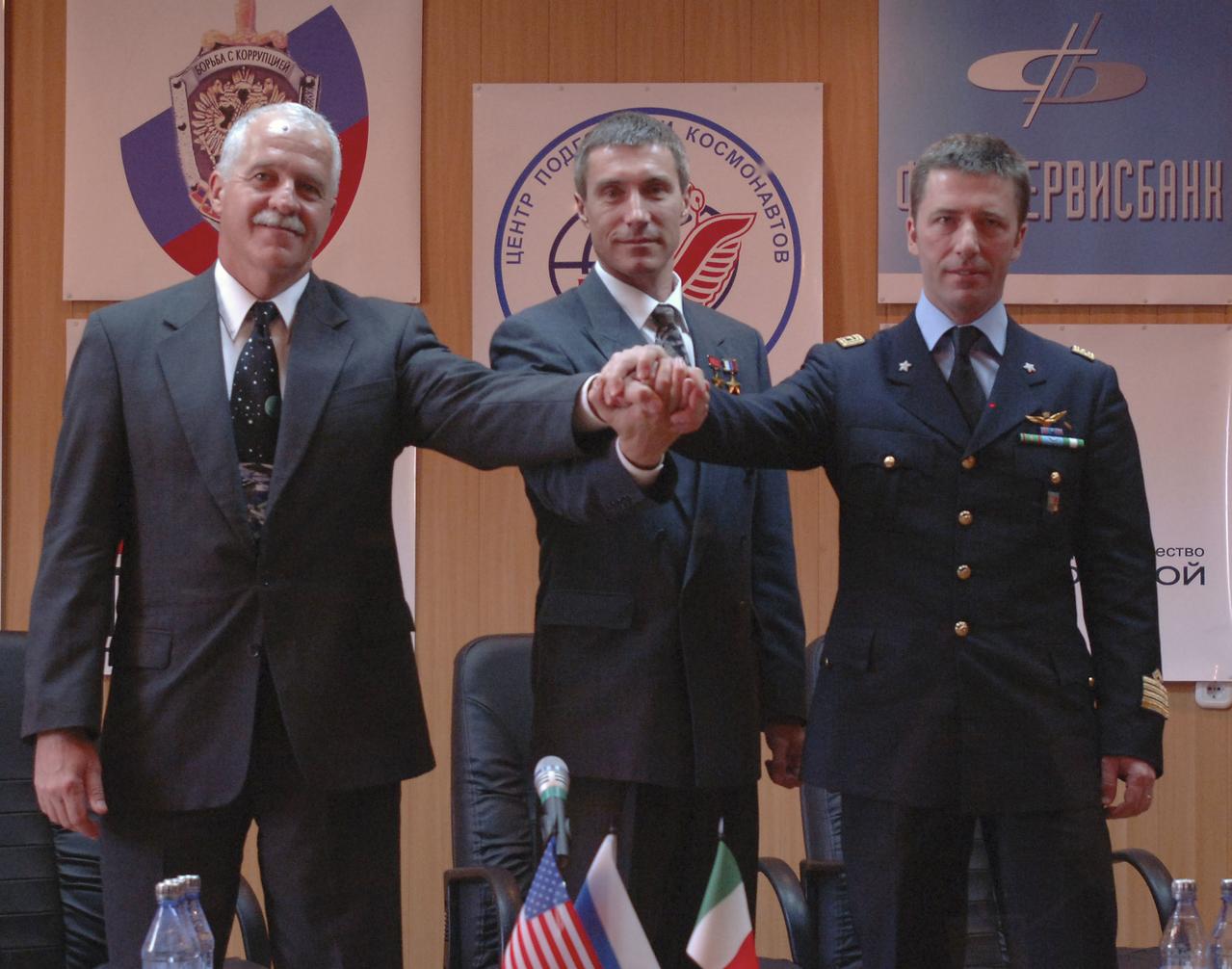 Expedition 11 Flight Engineer and NASA Science Officer John Phillips, left, crew Commander Sergei Krikalev and European Space Agency Astronaut Roberto Vittori, of Italy, join together at a press conference, Thursday, April 14, 2005, prior to their April 15 launch aboard the Soyuz TMA-6 spacecraft from the Baikonur Cosmodrome in Kazakhstan. Krikalev and Phillips will spend six months on the station, replacing Expedition 10 Commander Leroy Chiao and Flight Engineer Salizhan Sharipov, while Vittori will spend eight days on the Station under a commerical contract between ESA and the Russian Federal Space Agency, returning to Earth with Chiao and Sharipov on April 25. Photo Credit: (NASA/Bill Ingalls)