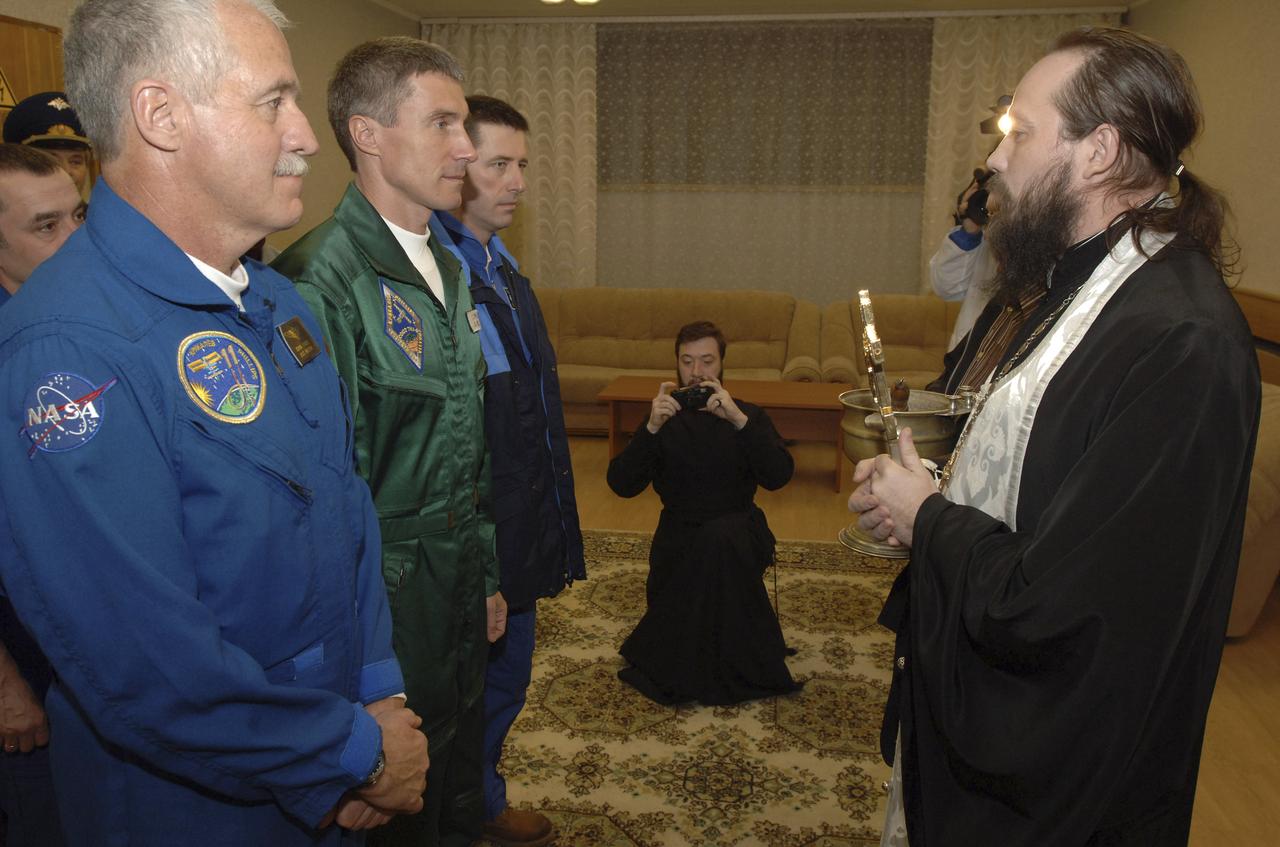 Expedition 11 Flight Engineer and NASA Science Officer John Phillips, left, Commander Sergei Krikalev and European Space Agency Astronaut Roberto Vittori, of Italy, receive the traditional pre-launch blessing, Thursday, April 14, 2005, prior to their launch aboard the Soyuz TMA-6 spacecraft from the Baikonur Cosmodrome in Kazakhstan. Krikalev and Phillips will spend six months on the station, replacing Expedition 10 Commander Leroy Chiao and Flight Engineer Salizhan Sharipov, while Vittori will spend eight days on the Station under a commercial contract between ESA and the Russian Federal Space Agency, returning to Earth with Chiao and Sharipov on April 25. Photo Credit: (NASA/Bill Ingalls)