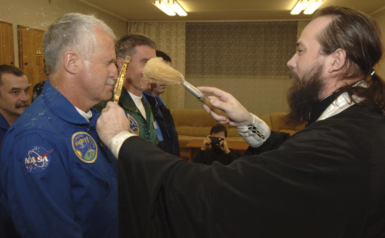 Expedition 11 Flight Engineer and NASA Science Officer John Phillips, left, Commander Sergei Krikalev and European Space Agency Astronaut Roberto Vittori, of Italy, receive the traditional pre-launch blessing, Thursday, April 14, 2005, prior to their launch aboard the Soyuz TMA-6 spacecraft from the Baikonur Cosmodrome in Kazakhstan. Krikalev and Phillips will spend six months on the station, replacing Expedition 10 Commander Leroy Chiao and Flight Engineer Salizhan Sharipov, while Vittori will spend eight days on the Station under a commercial contract between ESA and the Russian Federal Space Agency, returning to Earth with Chiao and Sharipov on April 25. Photo Credit: (NASA/Bill Ingalls)