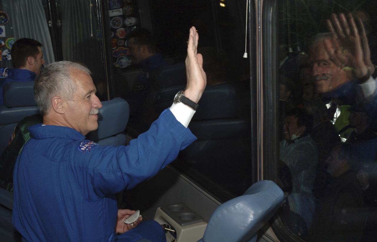 Expedition 11 Flight Engineer and NASA Science Officer John Phillips waves from the bus, Thursday, April 14, 2005, upon departure for launch aboard the Soyuz TMA-6 spacecraft from the Baikonur Cosmodrome in Kazakhstan. Photo Credit: (NASA/Bill Ingalls)