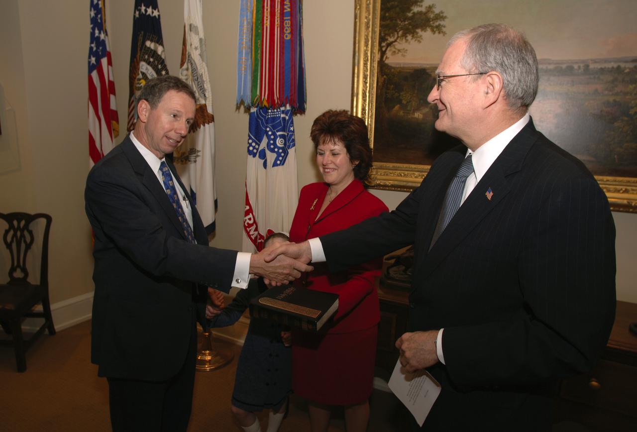 NASA Administrator Michael Griffin, left, is administered the oath of office by John H. Marburger, right, Science Adviser to the President and Office of Science and Technology Policy Director, during a private ceremony at the Old Executive Office Building, Thursday, April 14, 2005, in Washington, while his wife Rebecca and daughter Katie look on. Photo Credit: (NASA/Renee Bouchard)