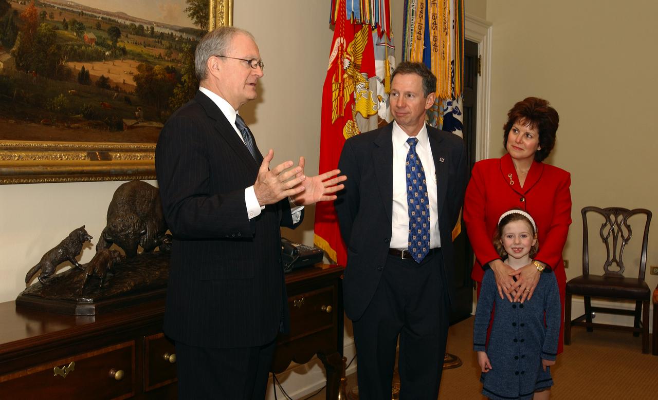 John H. Marburger, Science Adviser to the President and Director of the Office of Science and Technology Policy (OSTP), left, talks with NASA Administrator Michael Griffin, center, while his wife Rebecca and daughter Katie look on following his swearing-in, Thursday, April 14, 2005, in Washington. Photo Credit: (NASA/Renee Bouchard)