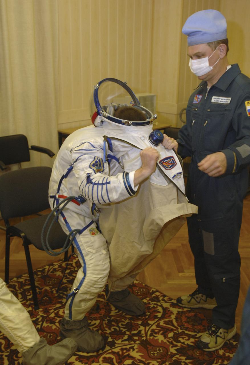 European Space Agency astronaut Roberto Vittori, right, is outfitted in his Russian Sokol suit, Friday, April 15, 2005, in Baikonur, Kazakhstan. Vittori, along with Expedition 11 Commander Sergei Krikalev and Flight Engineer and NASA Science Officer John Phillips were preparing for launch aboard the Soyuz TMA-6 spacecraft from the Baikonur Cosmodrome in Kazakhstan at daybreak on April 15 for a two-day trip to the International Space Station. Krikalev and Phillips will spend six months on the station, replacing Expedition 10 Commander Leroy Chiao and Flight Engineer Salizhan Sharipov, while Vittori will spend eight days on the Station under a commerical contract between ESA and the Russian Federal Space Agency, returning to Earth with Chiao and Sharipov on April 25. Photo Credit: (NASA/Bill Ingalls)