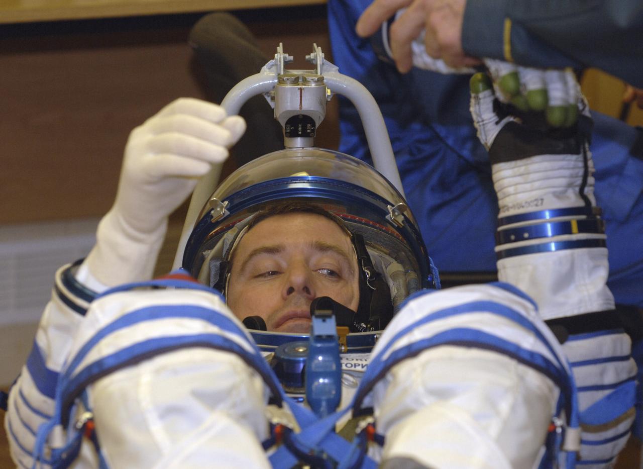 Technicians work on the Russian Sokol suit of European Space Agency astronaut Roberto Vittori, of Italy, prior to launch aboard the Soyuz TMA-6 spacecraft at the Baikonur Cosmodrome in Baikonur, Kazakhstan, Friday, April 15, 2005 for a two-day trip to the International Space Station.  Photo Credit: (NASA/Bill Ingalls) 