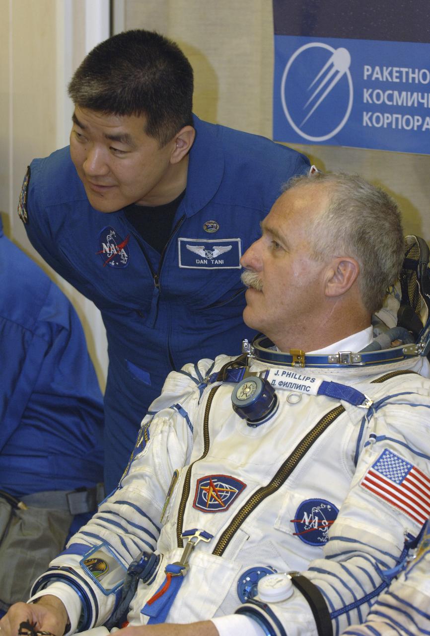 Expedition 11 Flight Engineer and NASA Science Officer John Phillips, right, talks with his backup Dan Tani during suit up at the Baikonur Cosmodrome in Kazakhstan on Friday, April 15, 2005, prior to launch aboard a Soyuz TMA-6 spacecraft for a two-day trip to the International Space Station. Photo Credit: (NASA/Bill Ingalls)